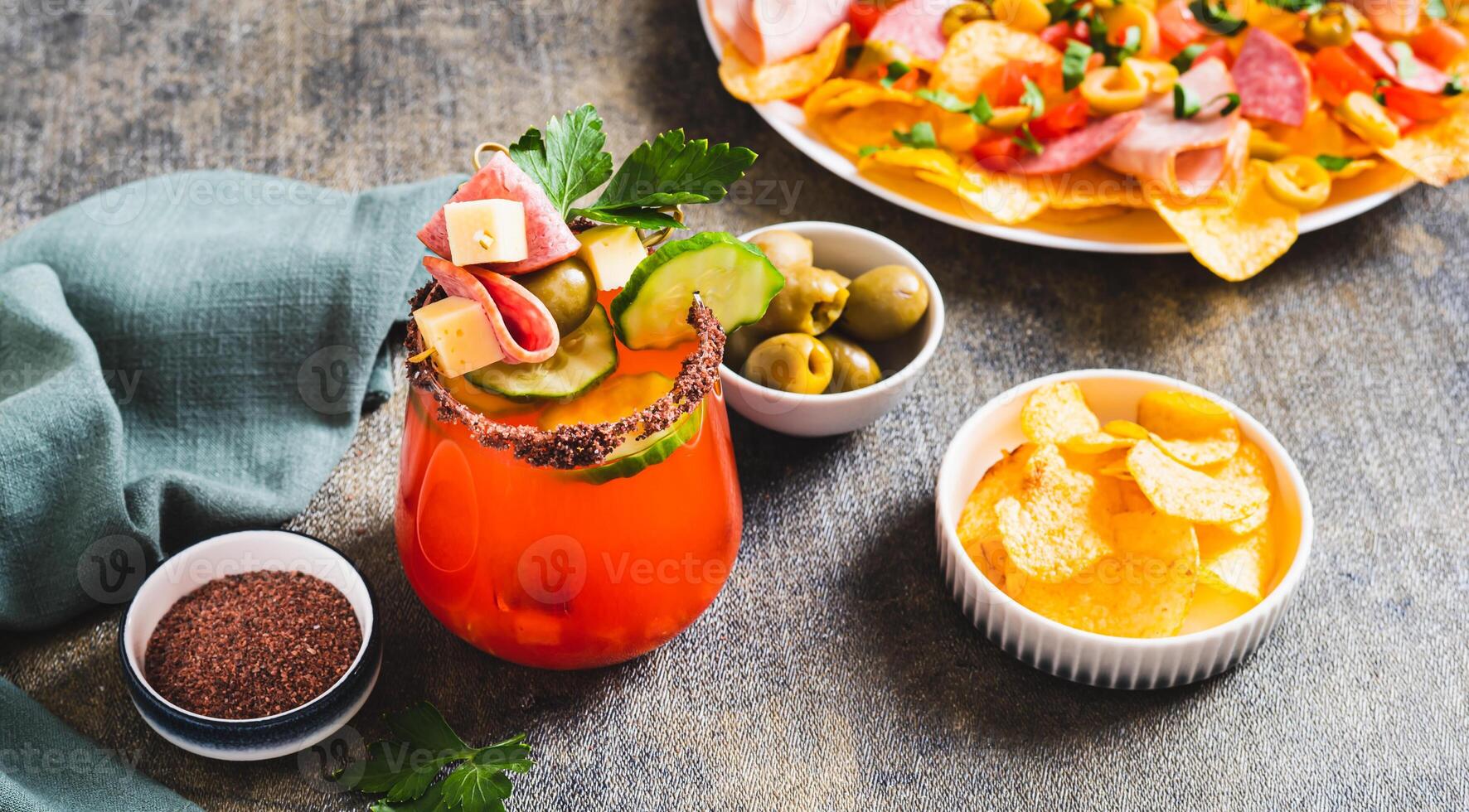 Cocktail and snack in one serving in a glass on the table web banner photo