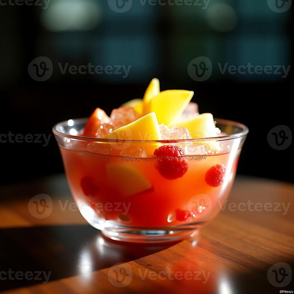 Serving Fruit Salad with Raspberries and Mango in Glass Bowl photo