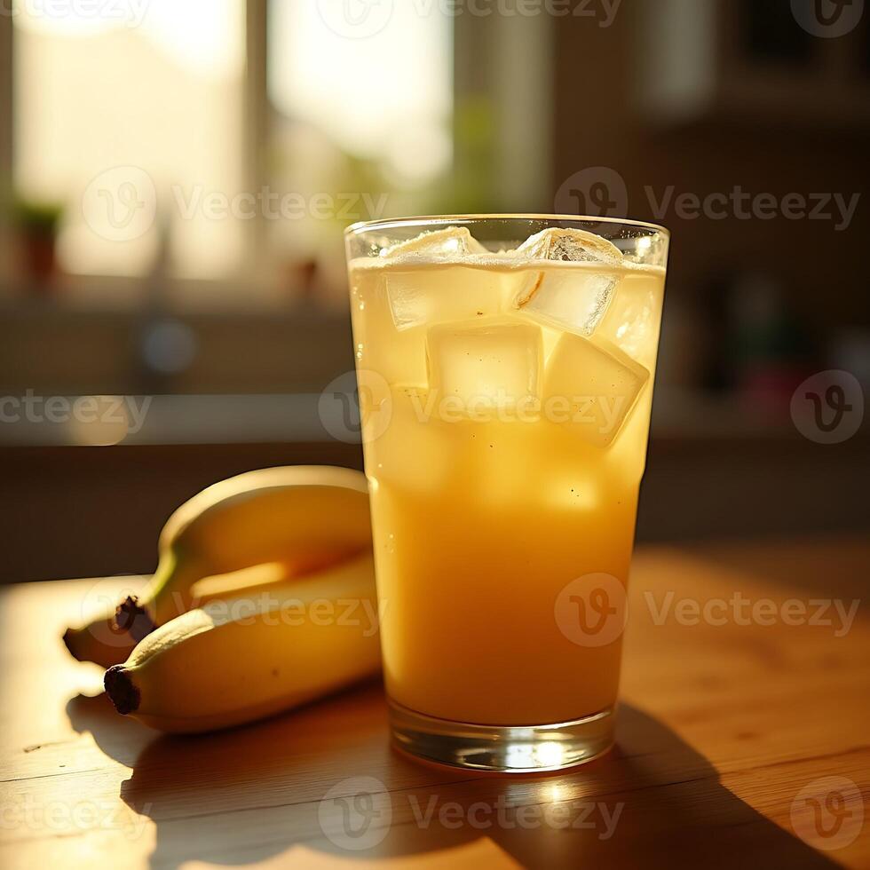 Refreshing Fruit Juice with Ice and Banana on Wooden Table photo