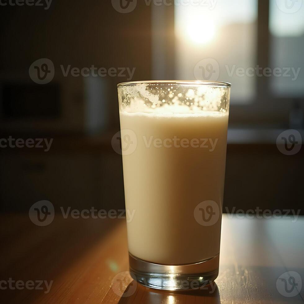 Pouring Glass of Milk on Table in Warm Sunlight photo