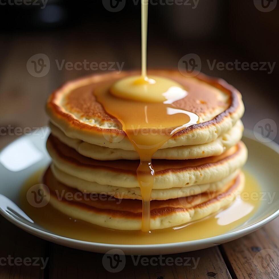 Stack of Pancakes with Syrup Pouring Over Food Photography photo