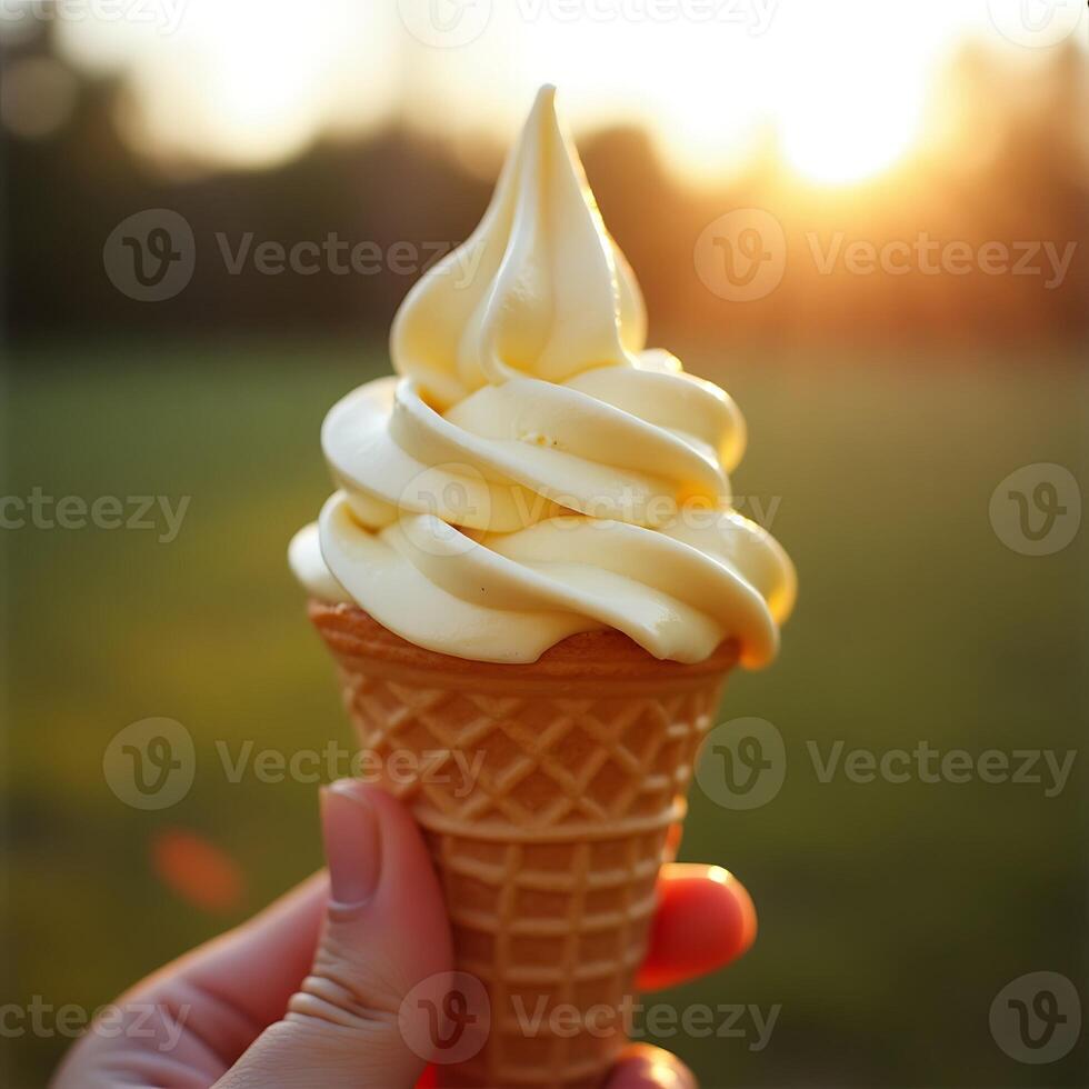 Holding Vanilla Soft Serve Ice Cream Cone at Sunset photo