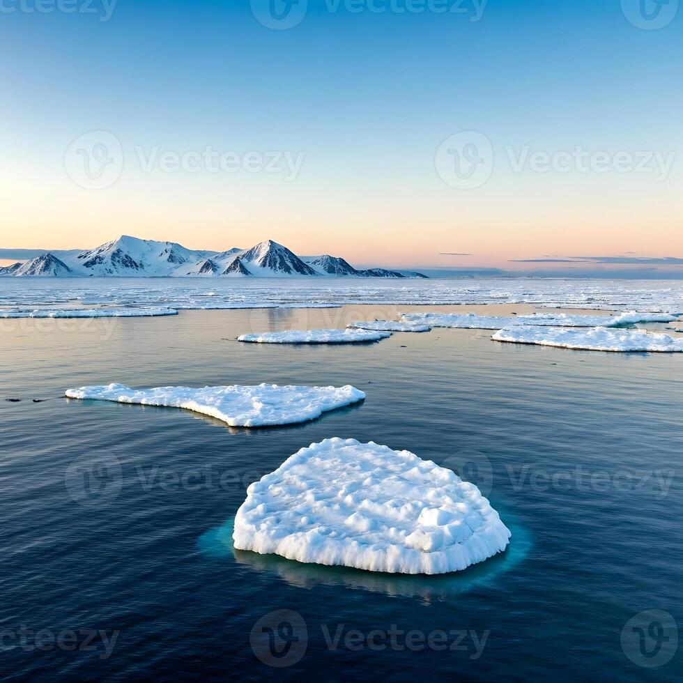 Icebergs floating in the ocean with mountains in the background photo