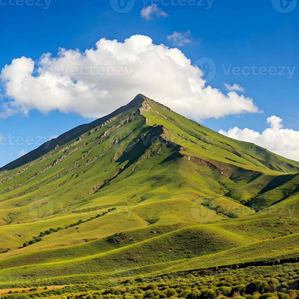 A mountain with a cloud in the sky photo