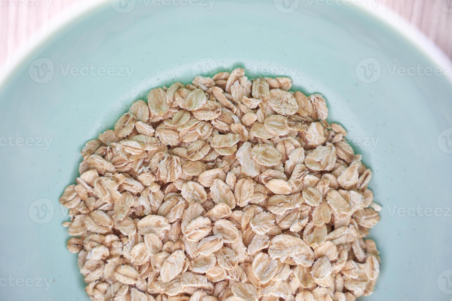 Healthy breakfast oats in light blue bowl highlighting nutritious whole grains for balanced diet and meal prep. photo