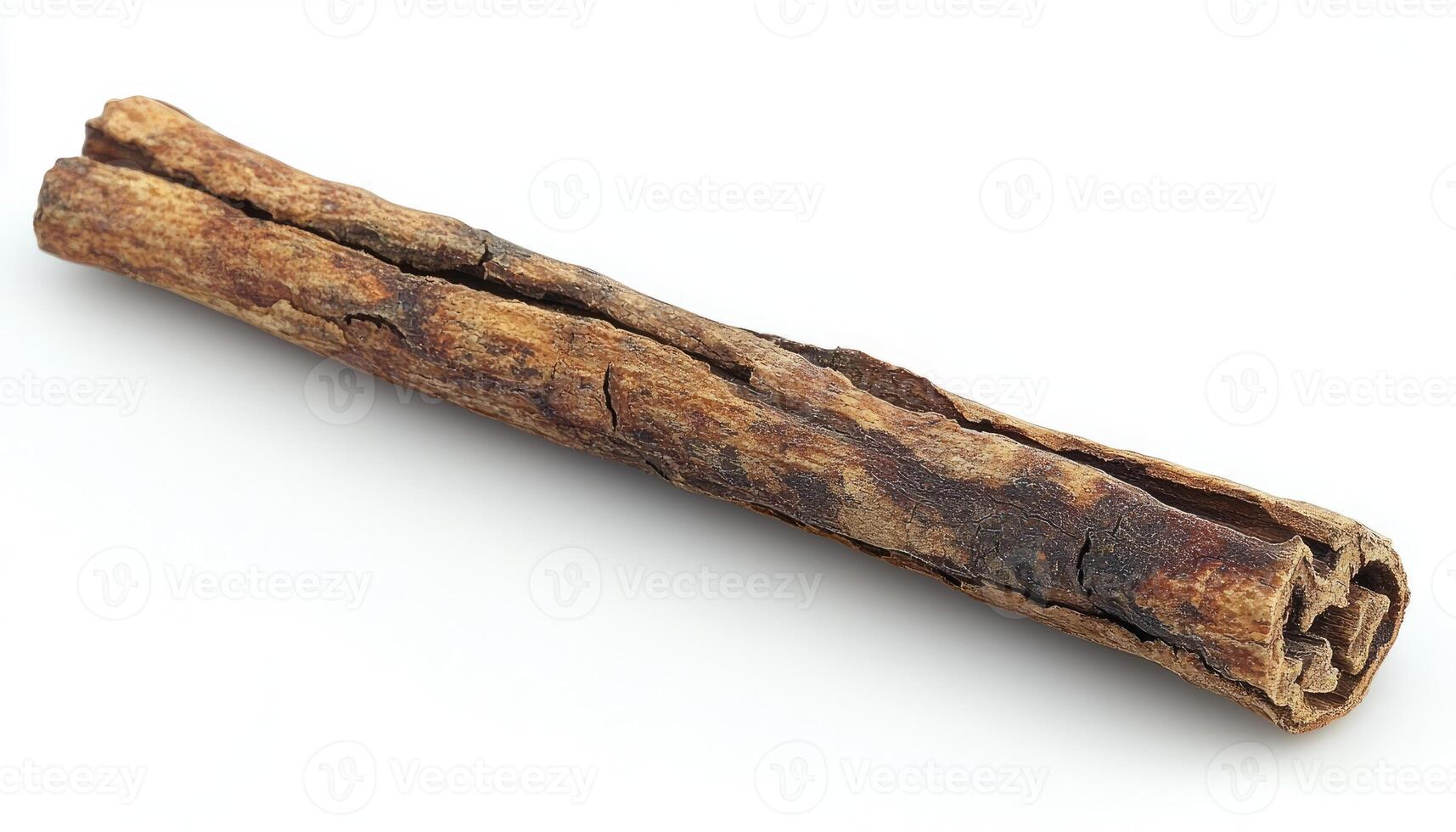 A single cinnamon stick laying on a plain white background photo