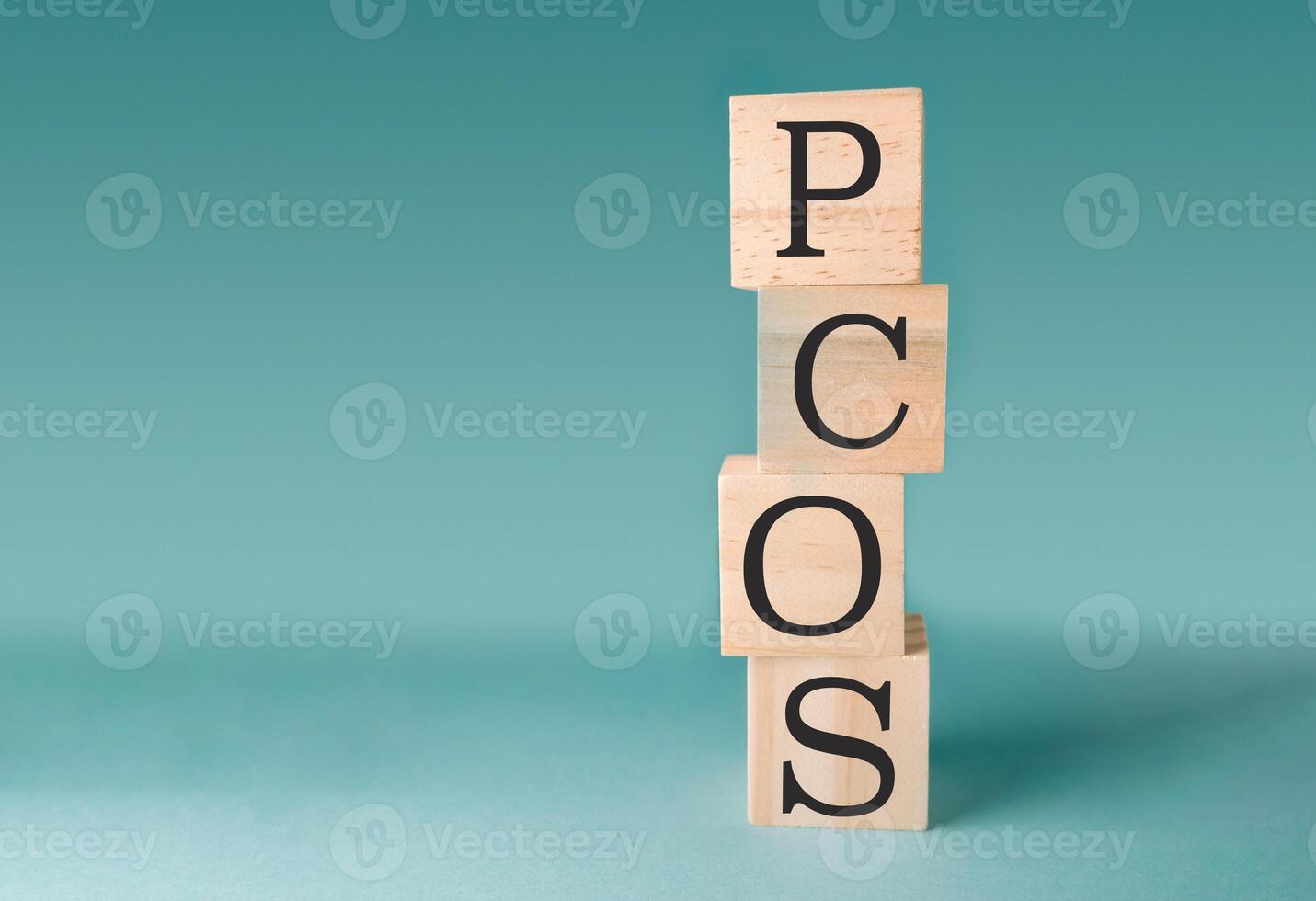 Stack of wooden blocks with the letters PCOS on top photo