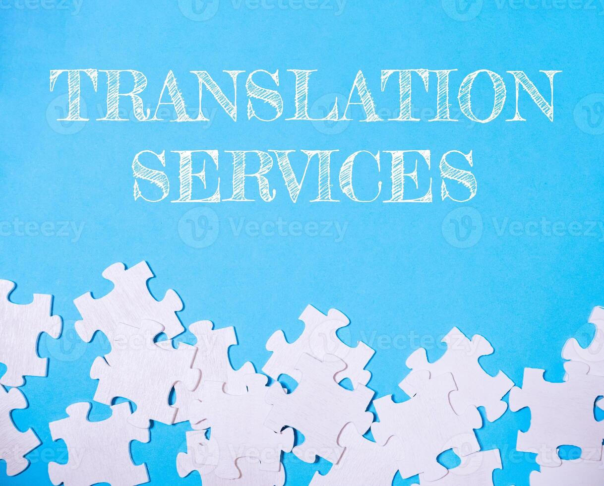 Blue background with white puzzle pieces and the words translation services photo