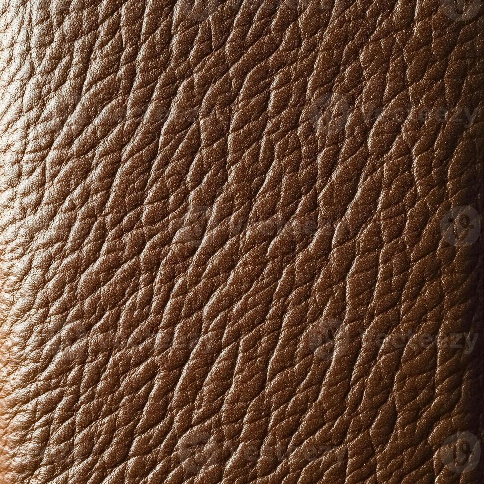 Brown leather surface with a grainy texture photo