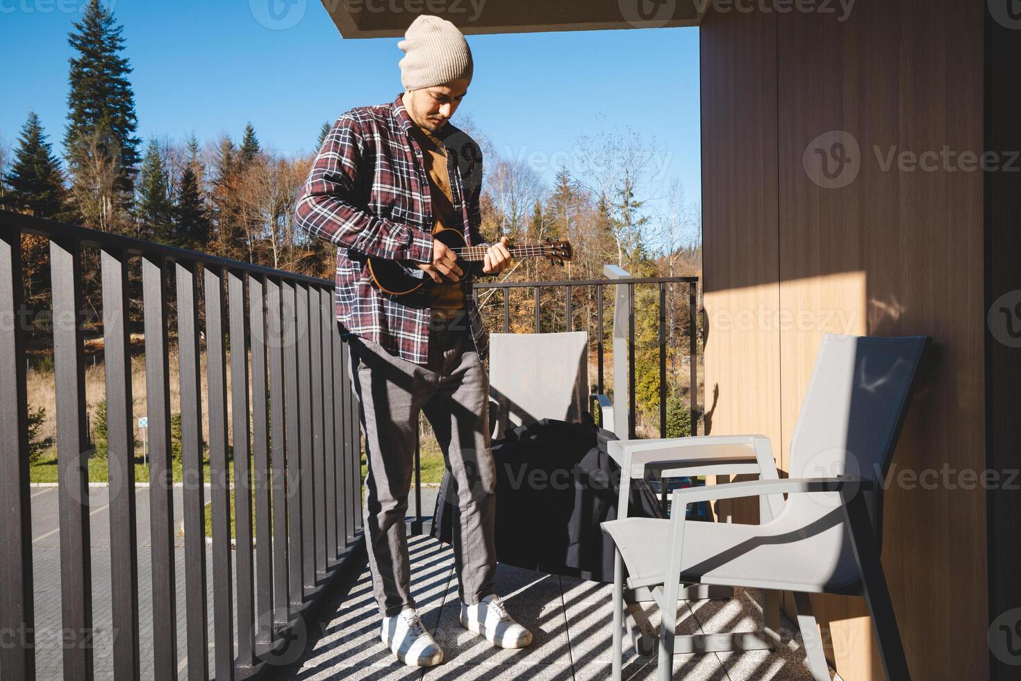 Wearing cozy clothes and playing a tune to the trees photo