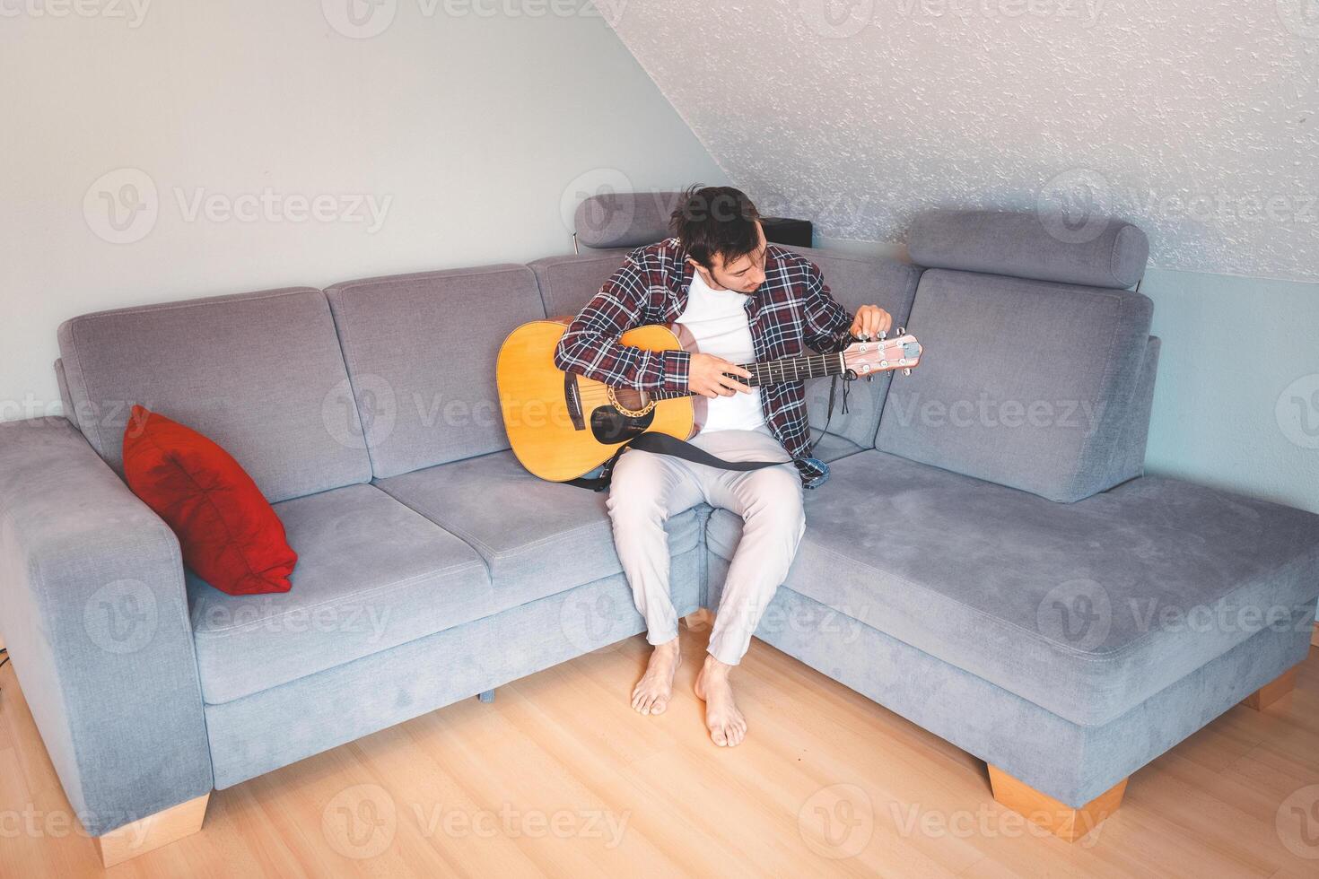 Man playing guitar while enjoying his free time photo