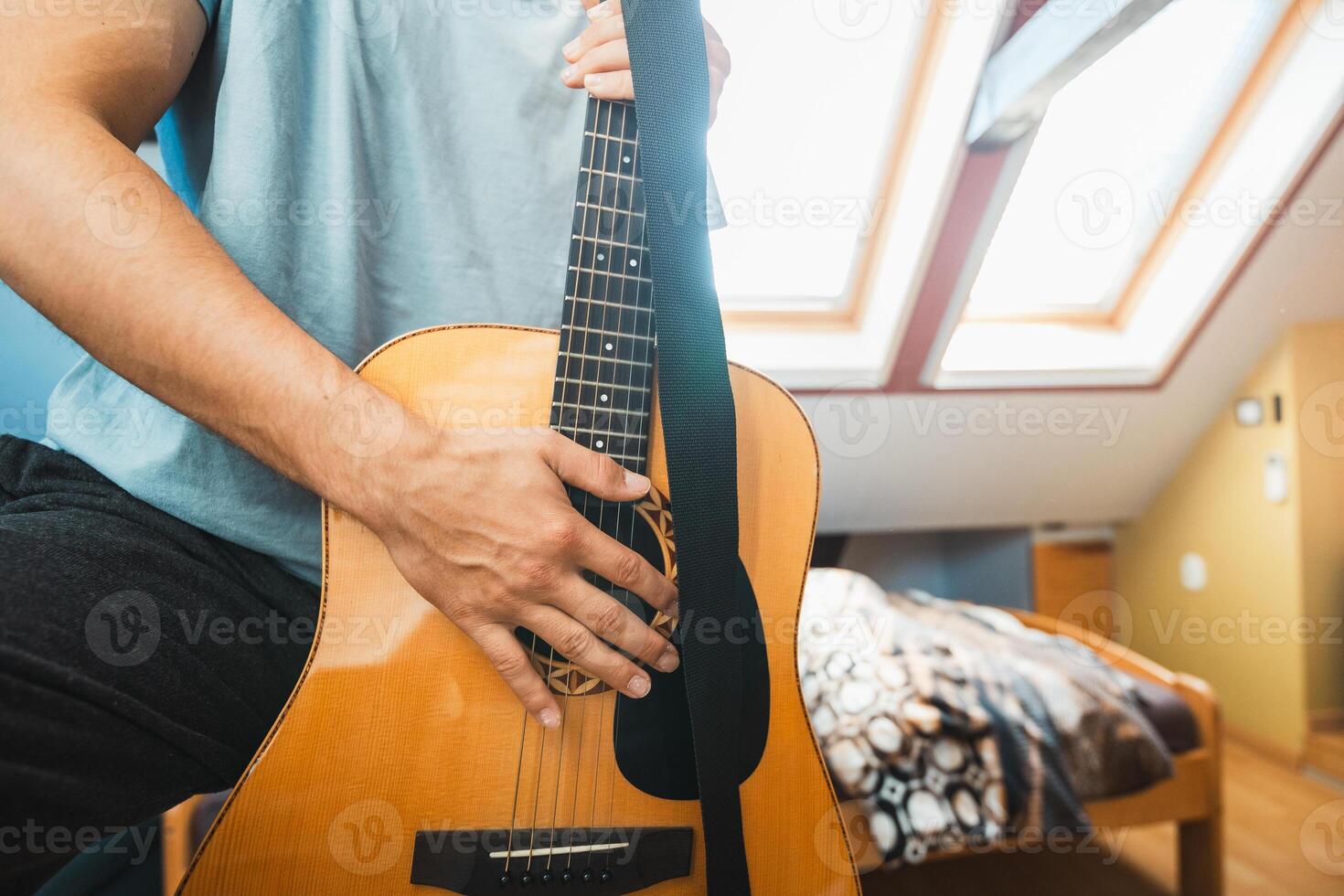 Guitar player finds comfort in a quiet afternoon photo