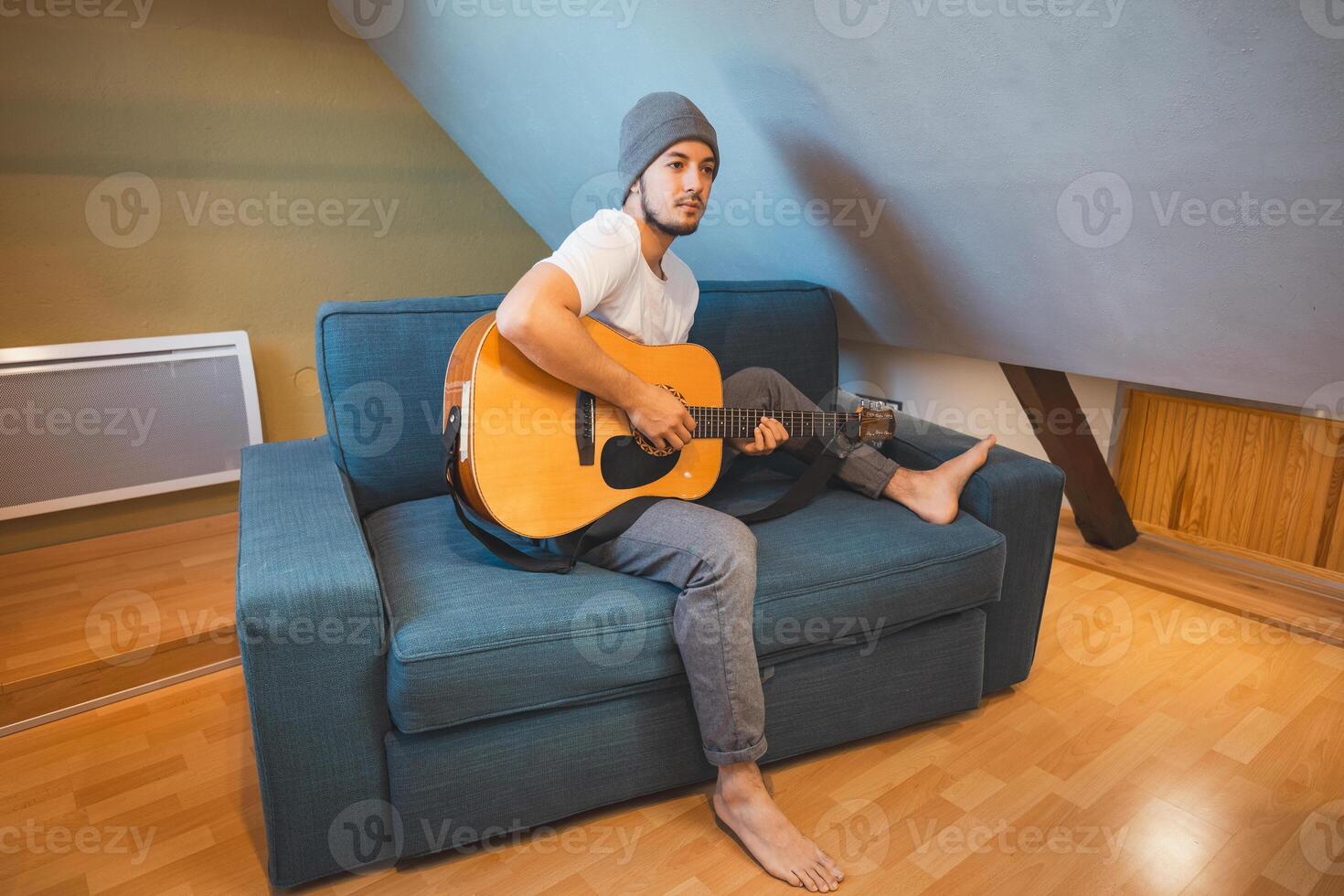 Simple pleasure of playing guitar in everyday clothes photo