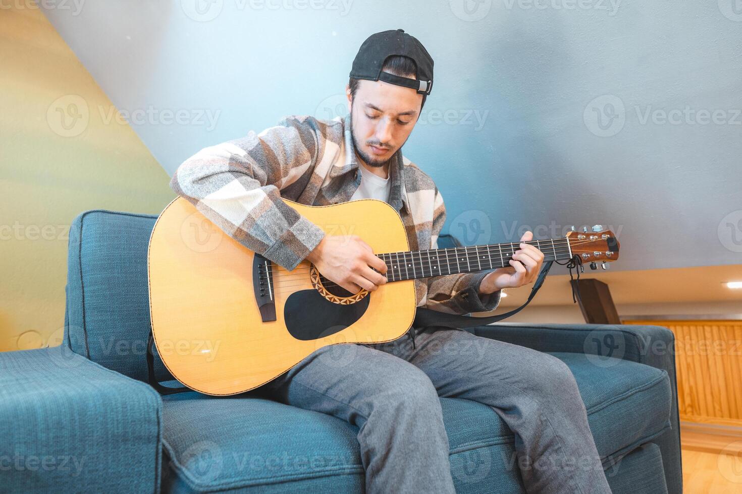 Strumming guitar alone in a minimalistic home setting photo