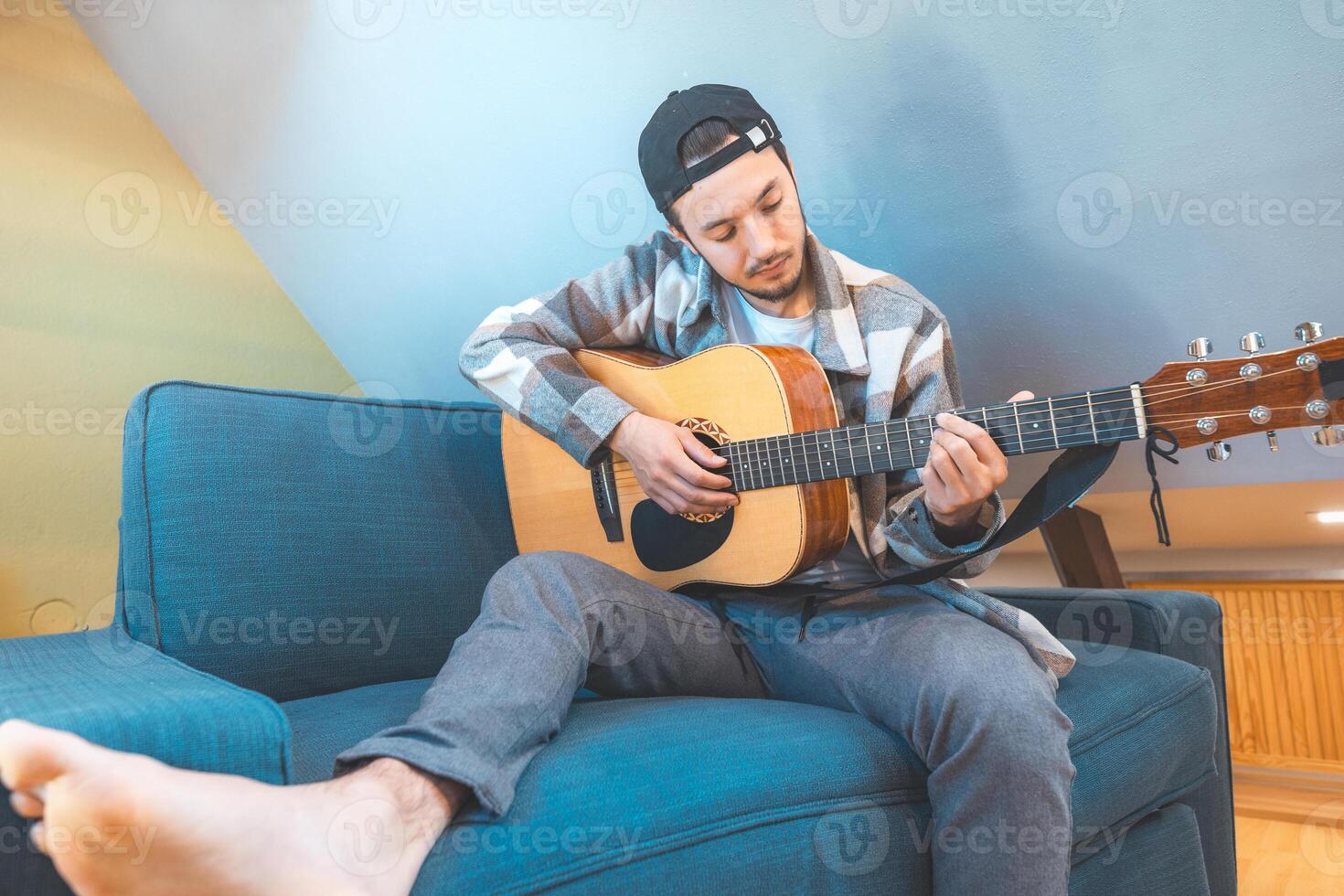 Natural light illuminates a man creating melodies photo