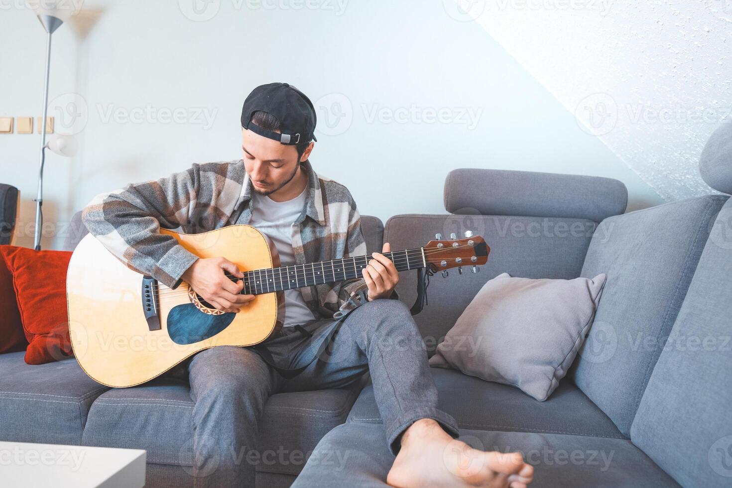 Hands gently strum the strings of an acoustic guitar photo