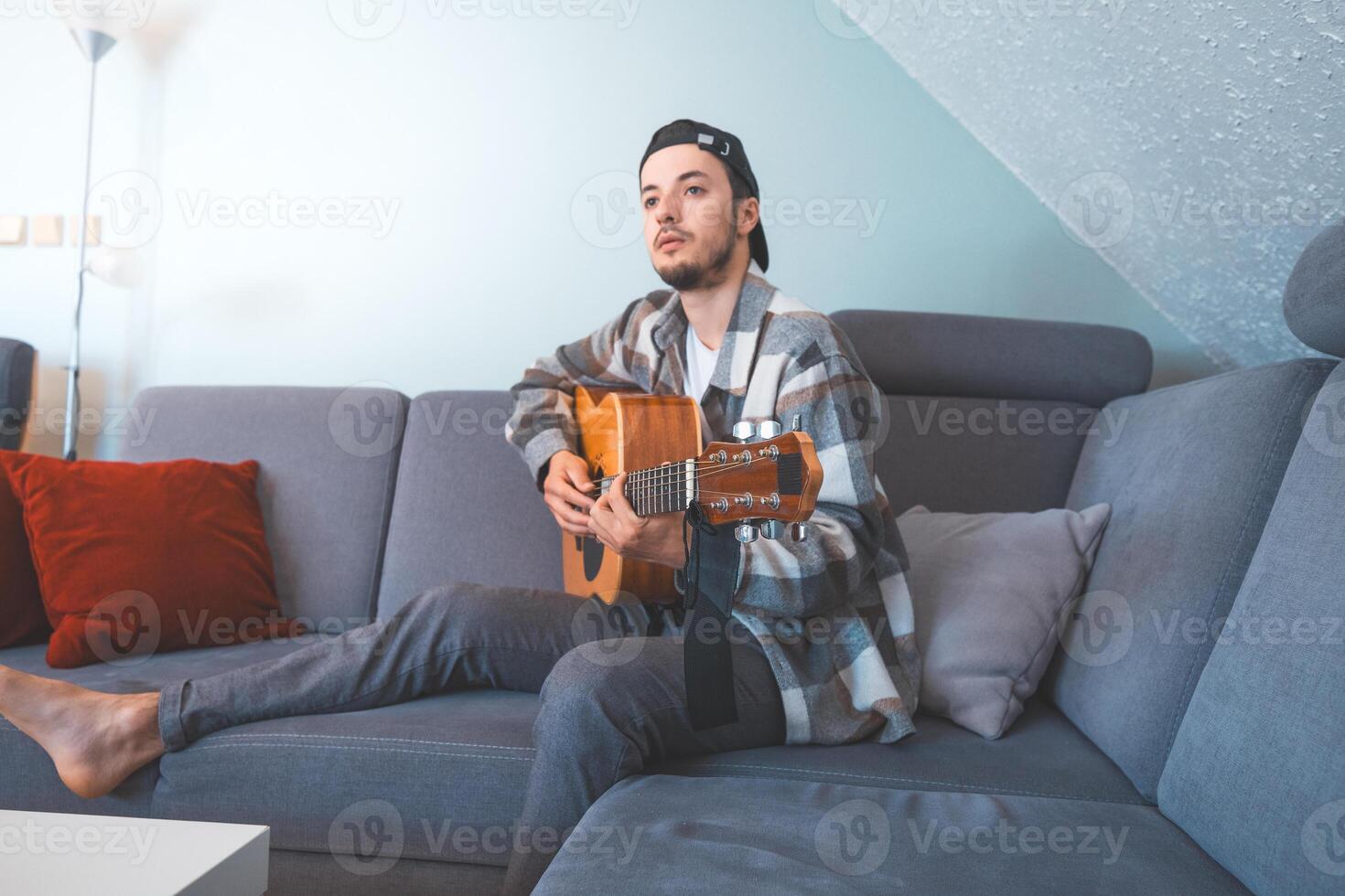 Calm energy as man plays chords on a warm wooden guitar photo