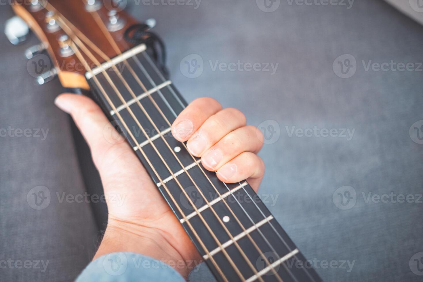 Detail on playing on guitar photo