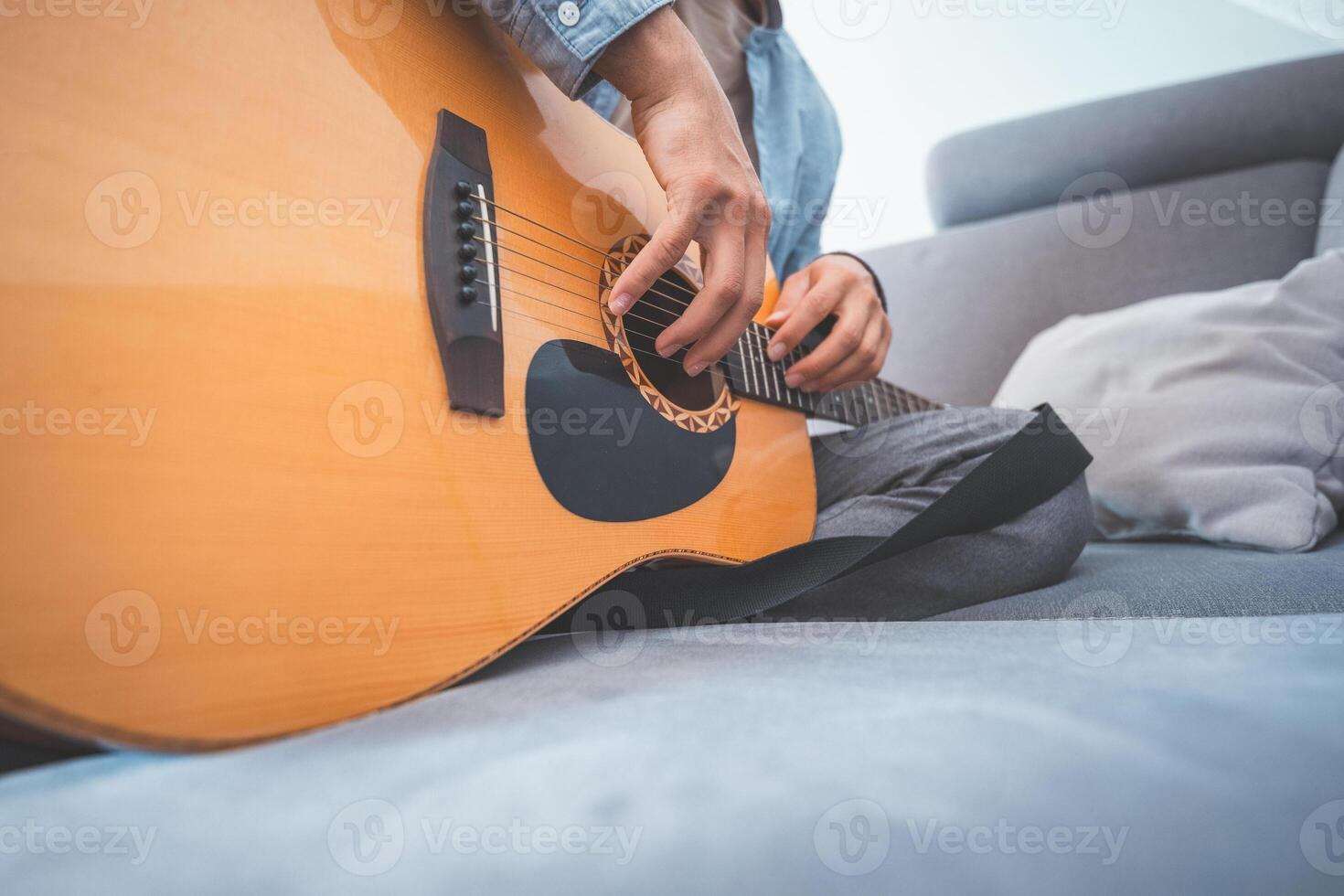 Acoustic guitar, lost in music. A peaceful home setting, soft lighting, and artistic inspiration create a warm, creative atmosphere photo