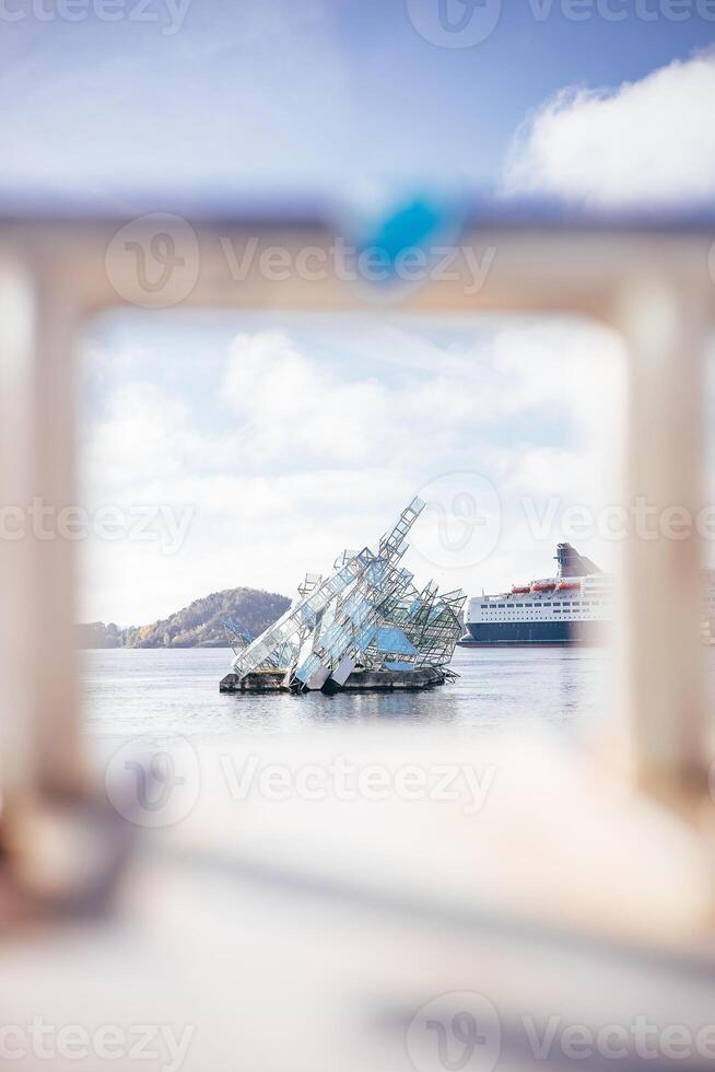 Crystal-like sculpture rises from Oslofjord surface, framed by soft focus and morning light art, sea, and sky merging in Norway capital photo