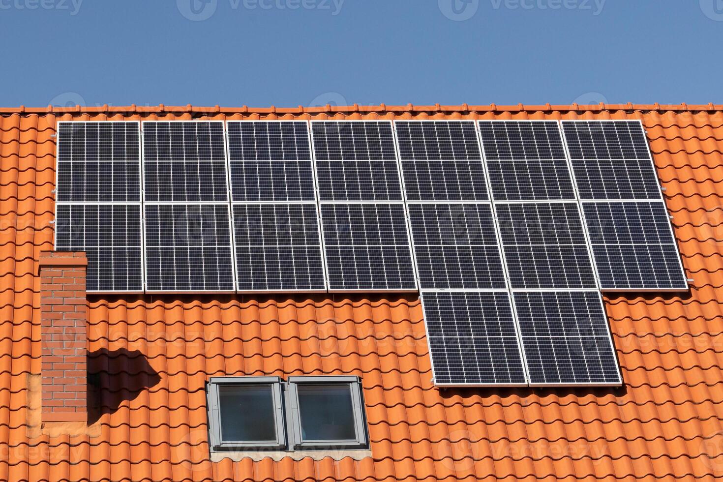 Solar panels on tiled house roof photo