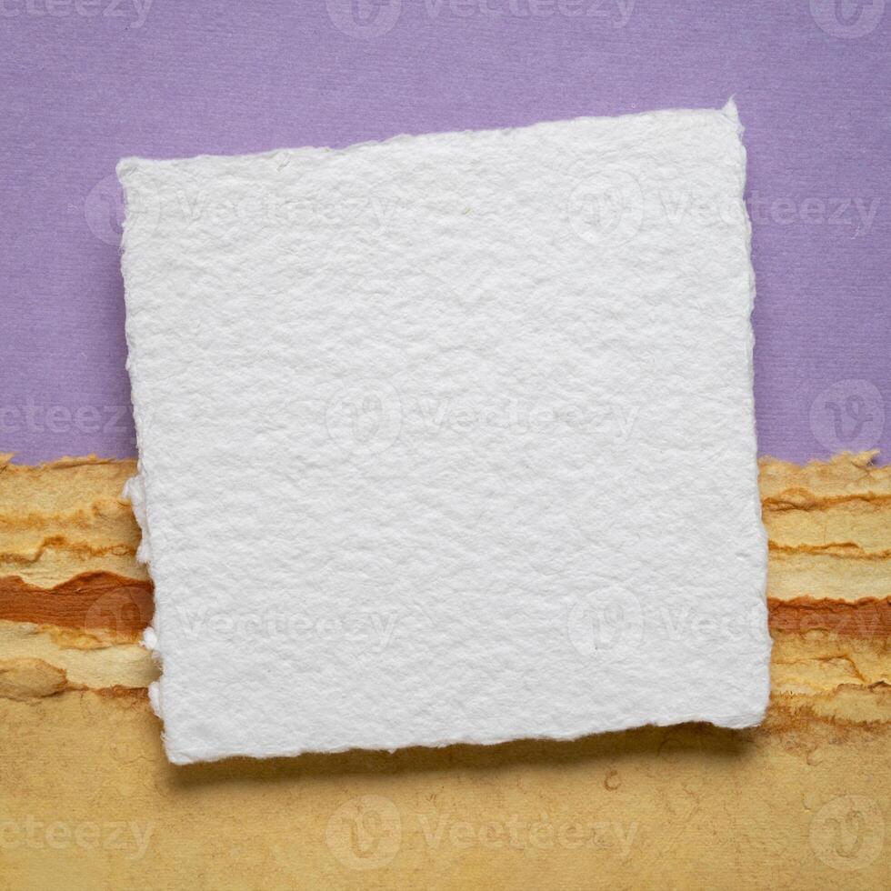blank sheet of watercolor paper on a tan art paper photo