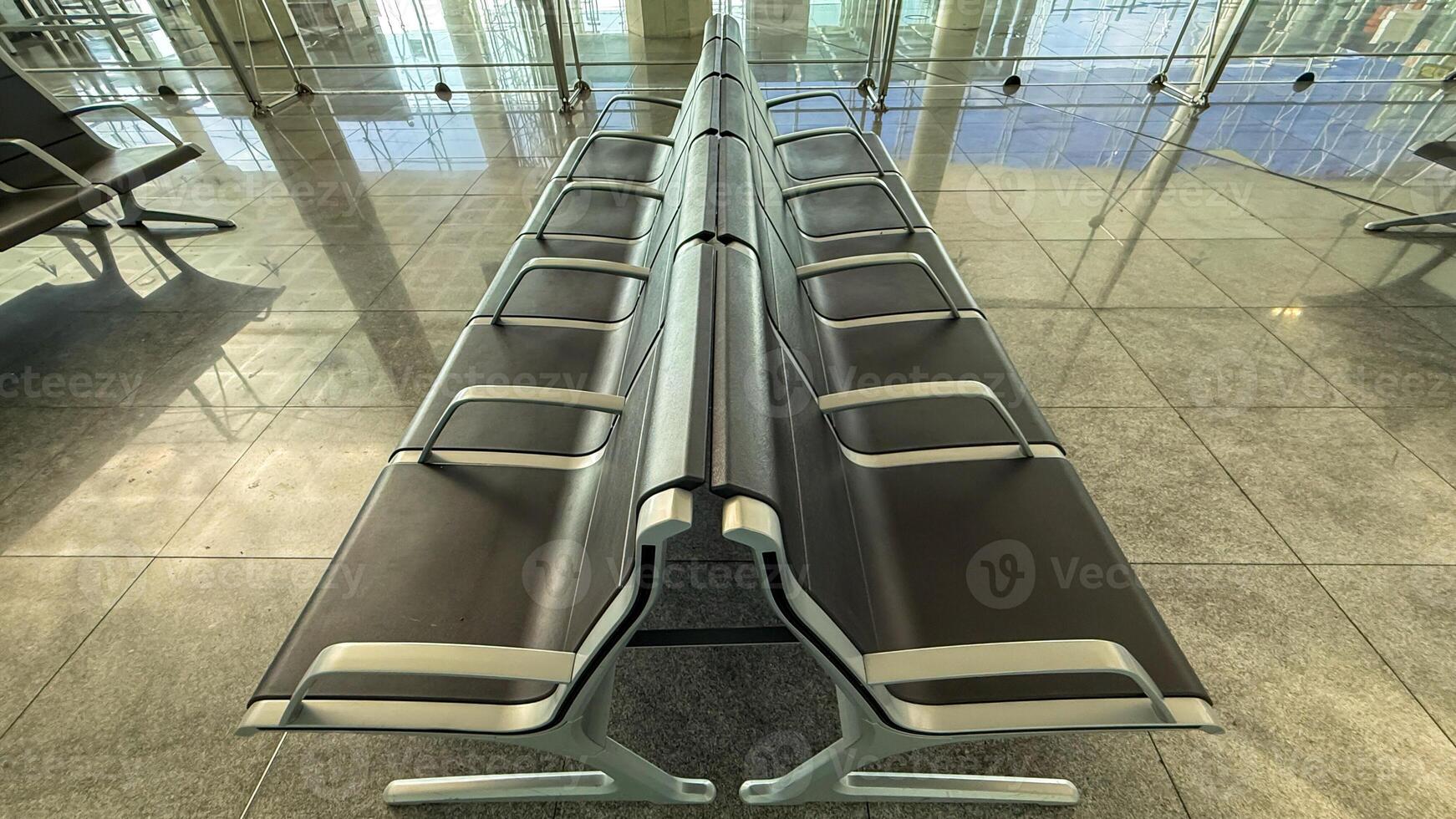 Futuristic airport bench aligns with symmetry, embodying transient liminality for solo traveler celebrates Global Travel Day and Terminal Silence photo