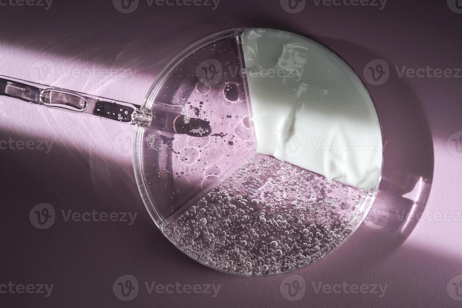 Cosmetic products in a petri dish on a purple background with a beautiful ray of light. photo