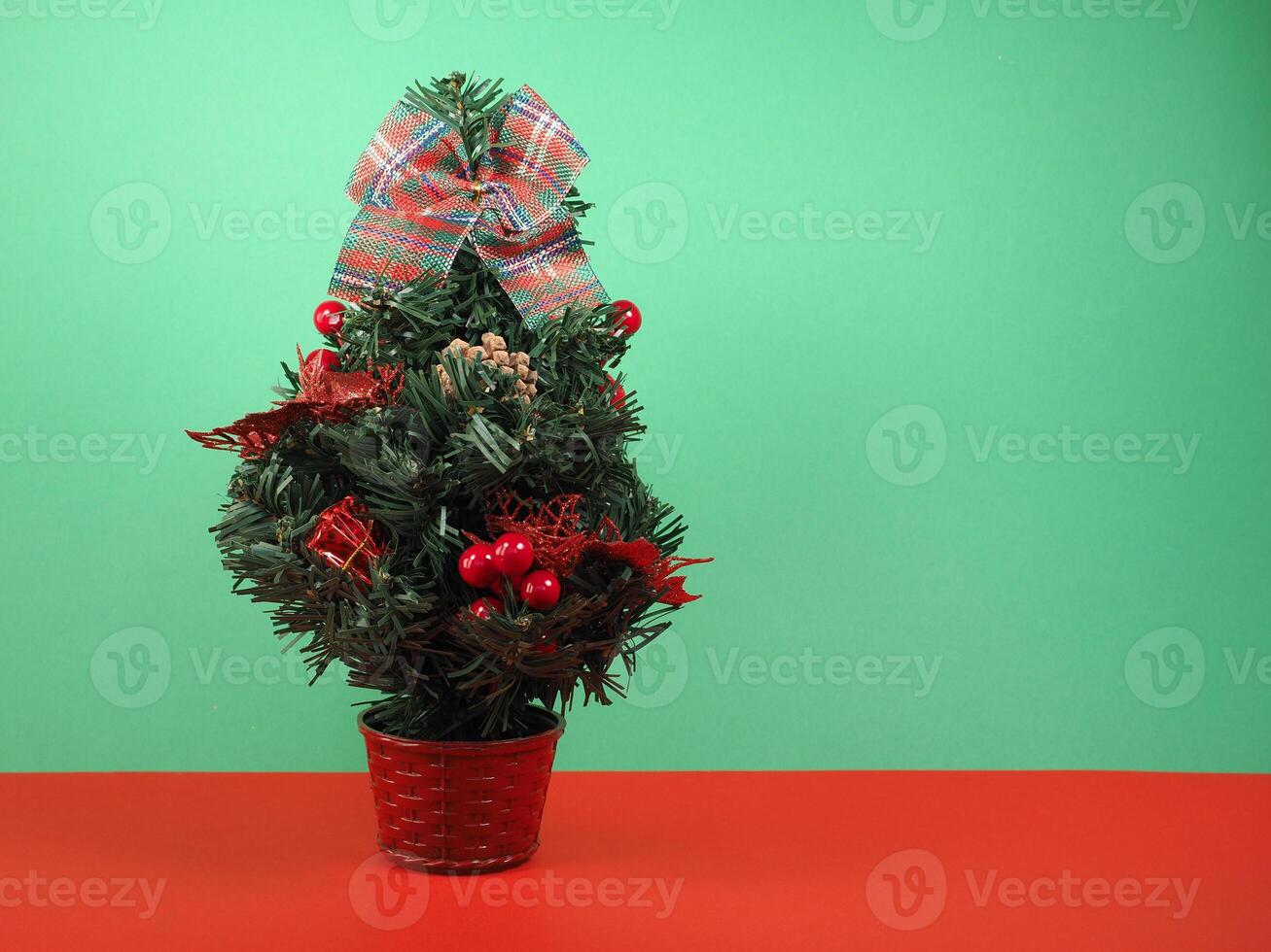 christmas tree over a green and red background photo