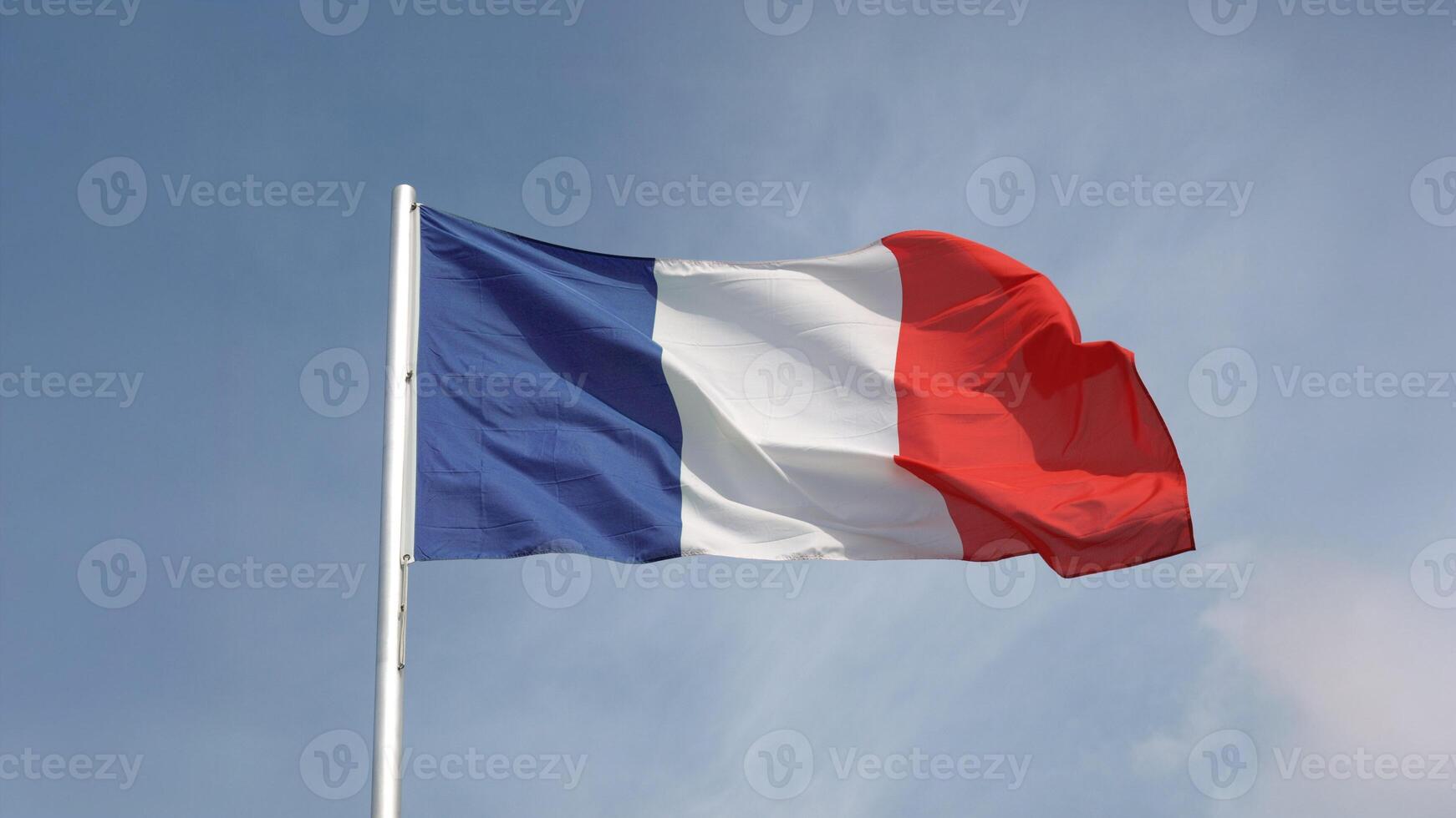 French flag of France over blue sky bg photo