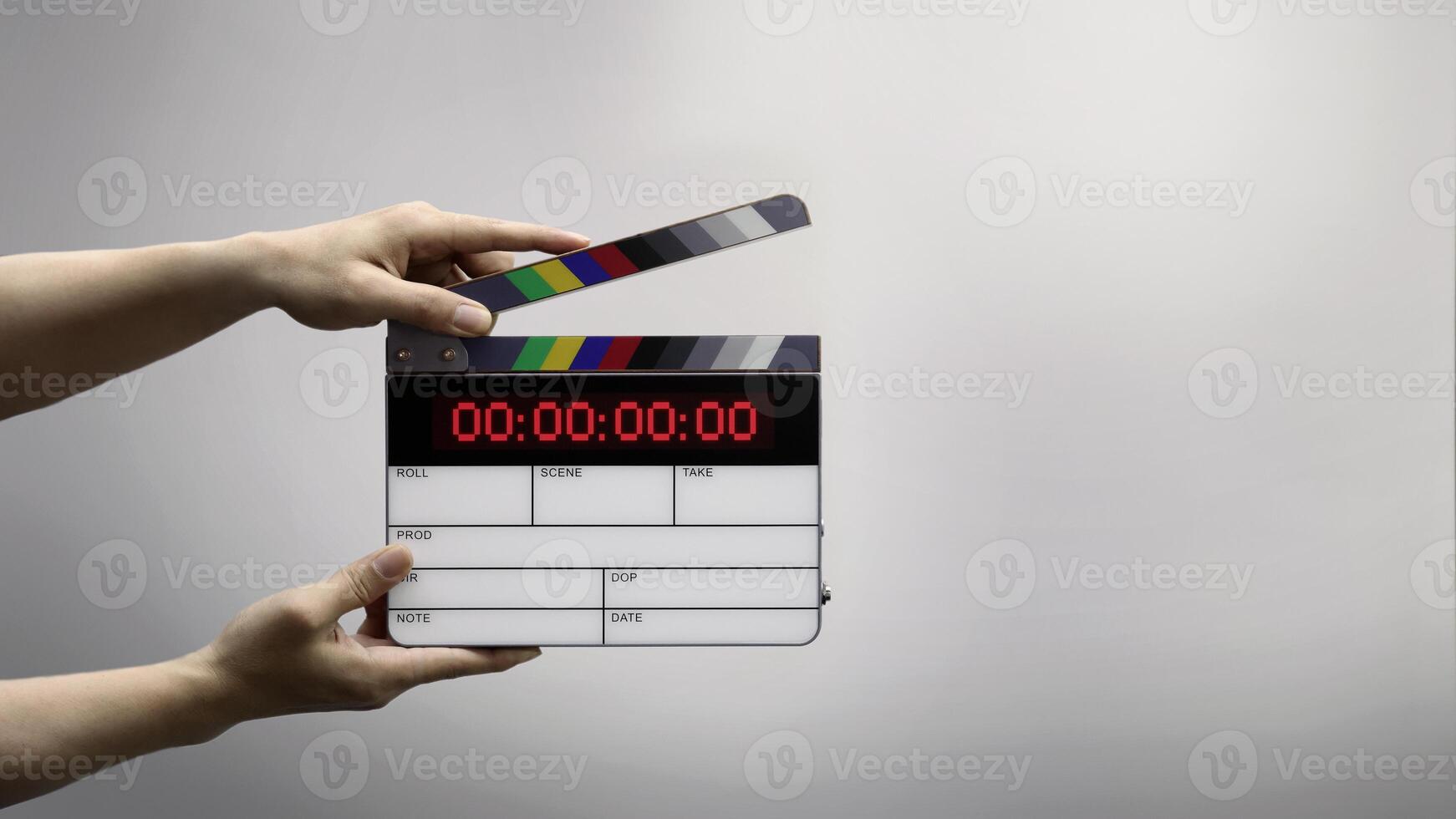 A Hand hitting timecode clapperboard or movie slate for Production. photo