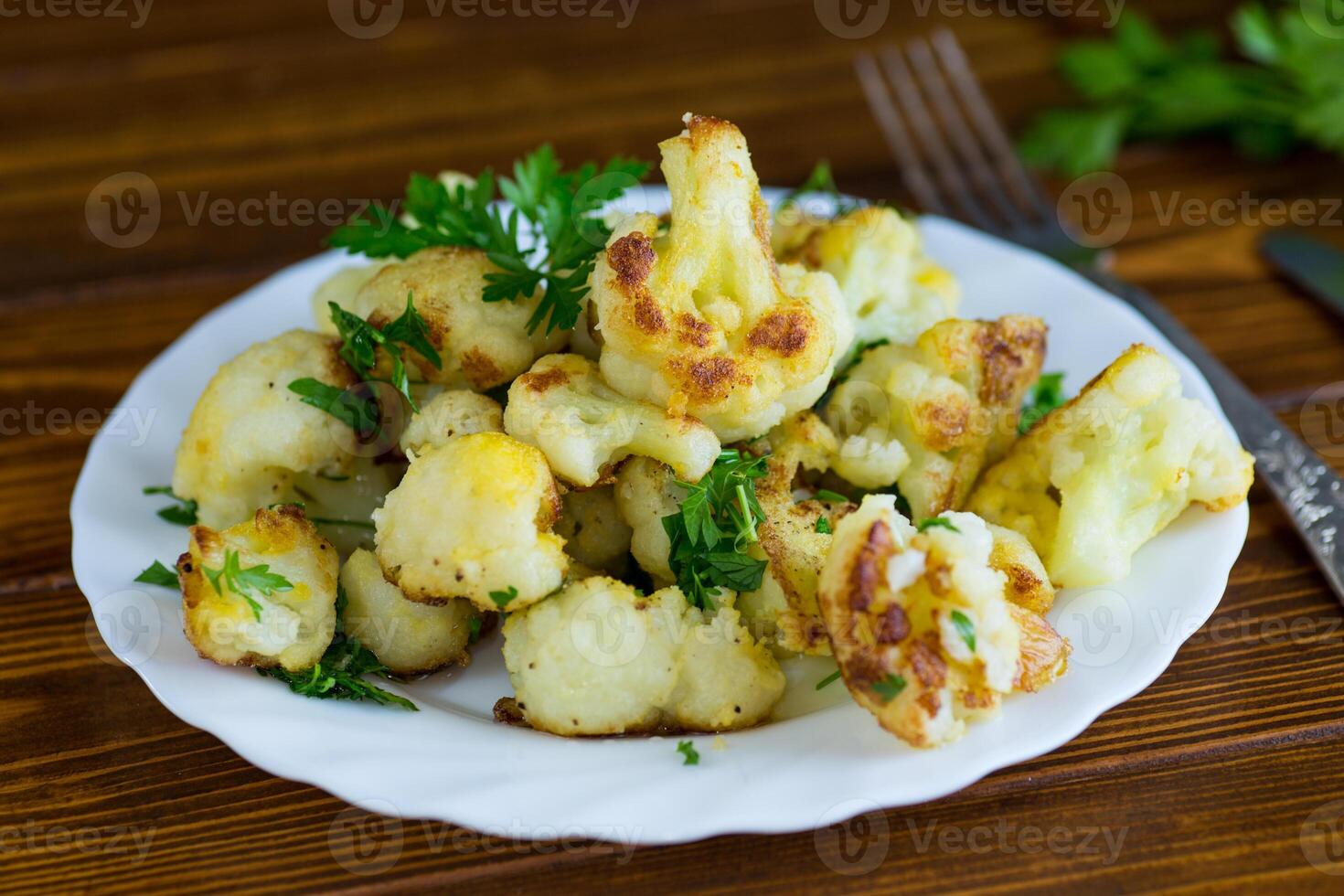 Appetizing fried cauliflower on a dark kitchen surface photo