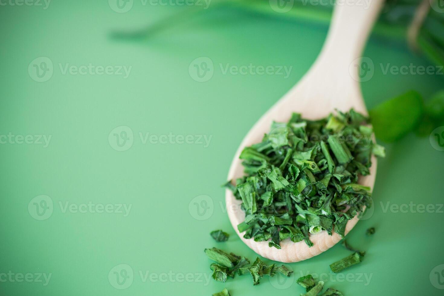 Slices of fresh and dried onions on green surface photo