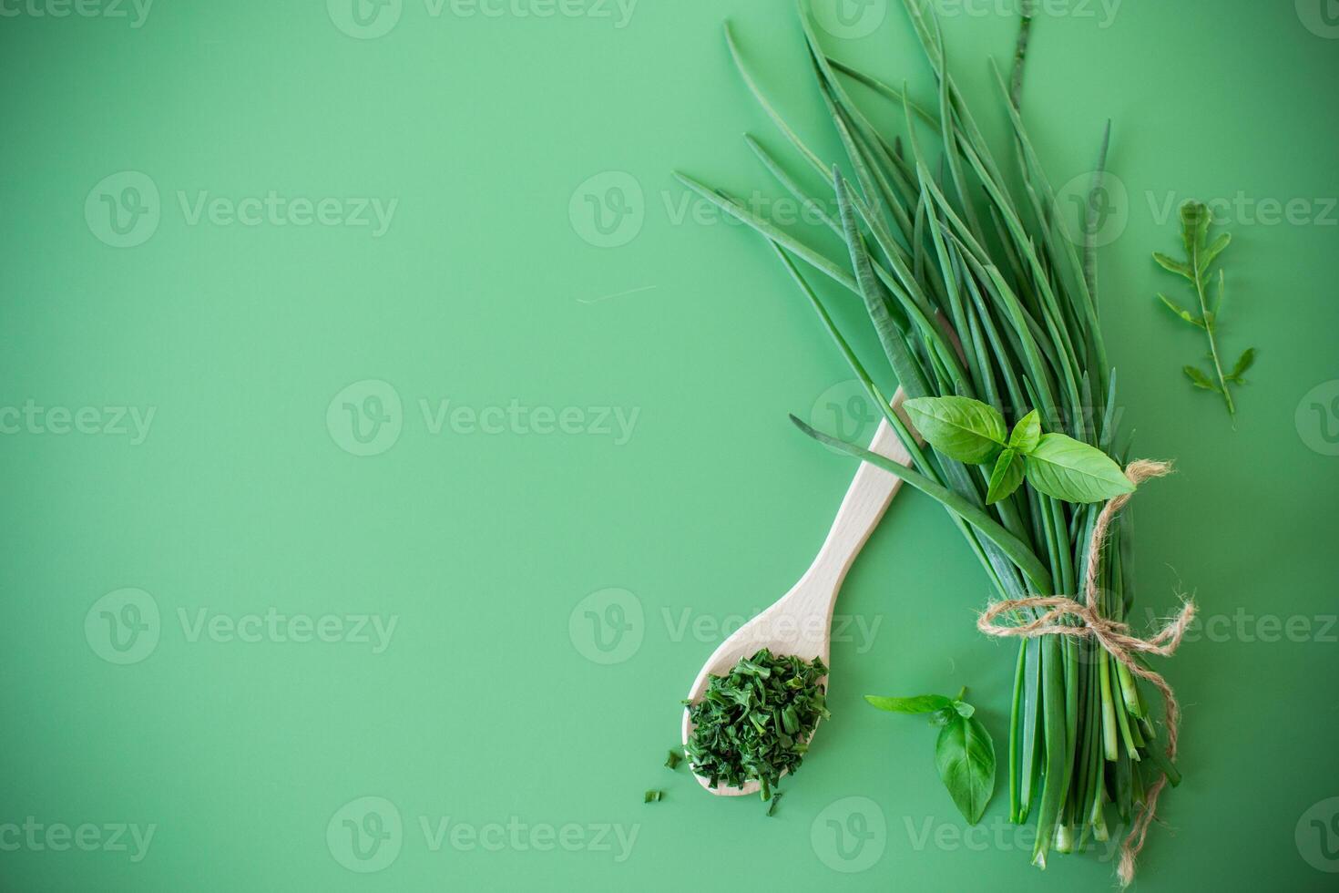 Slices of fresh and dried onions on green surface . photo