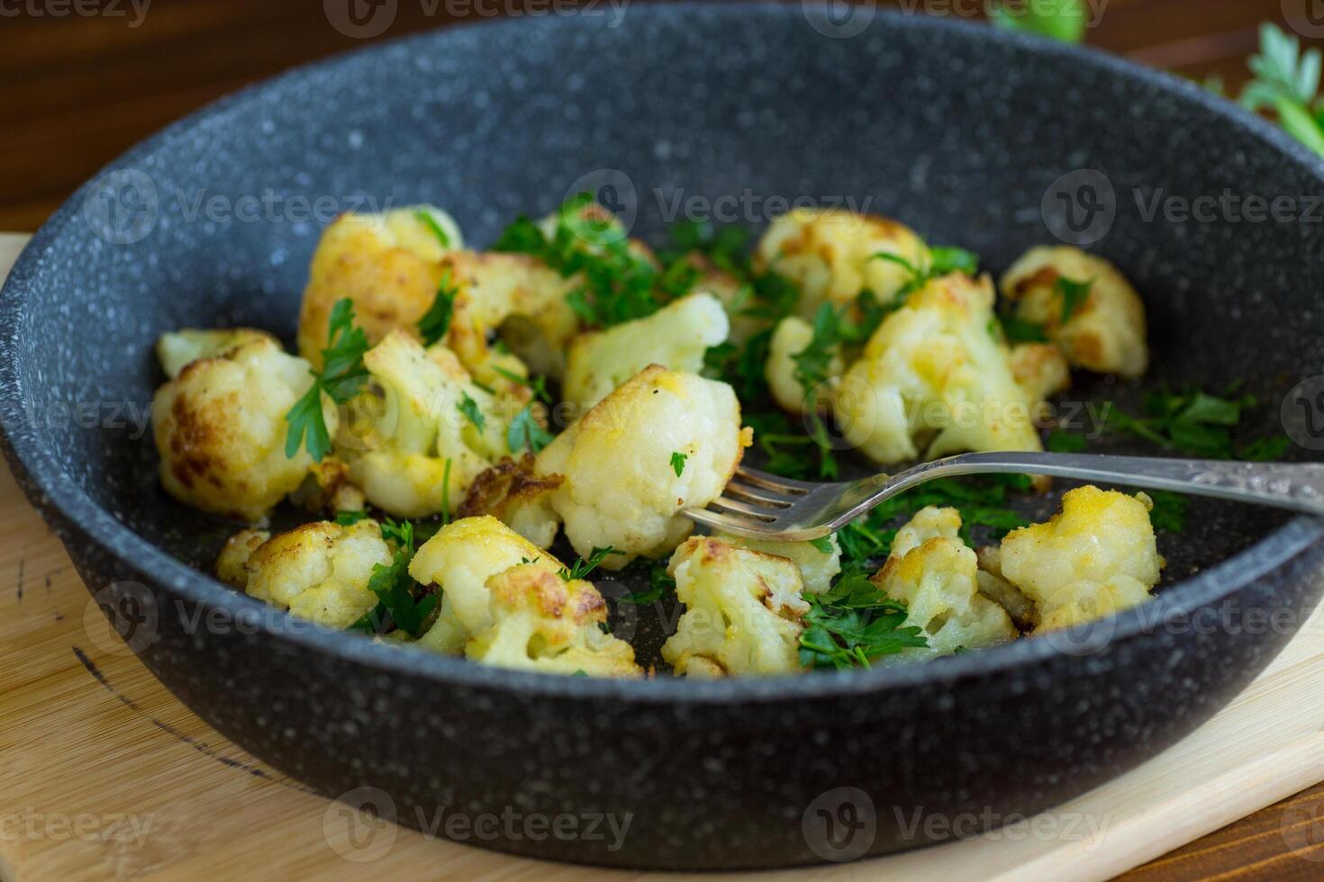 Top view of crispy cauliflower with parsley . photo
