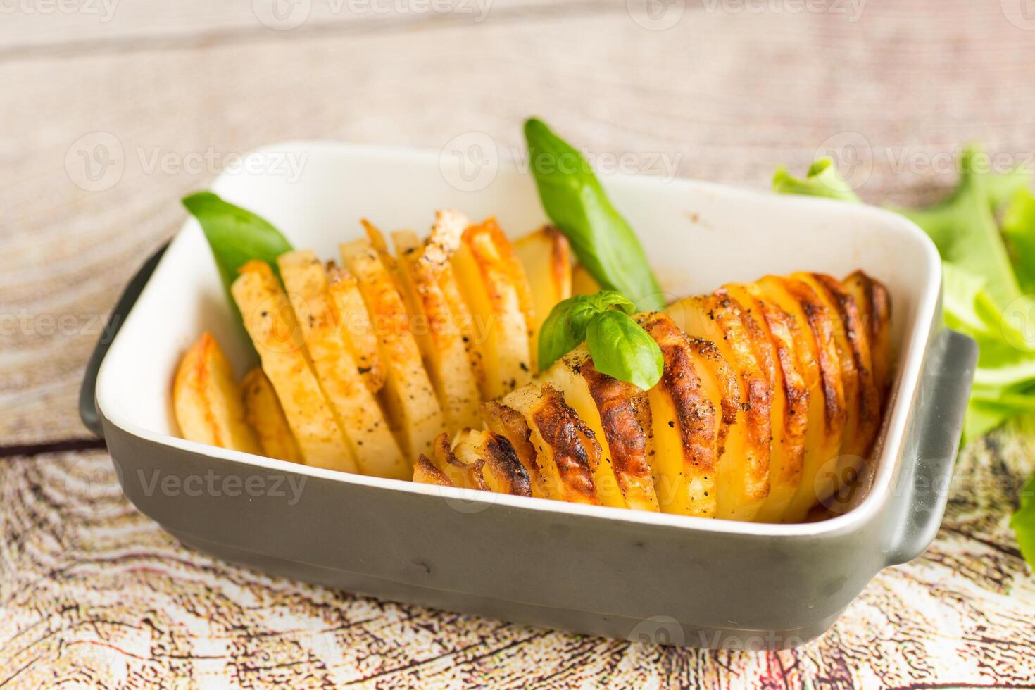 Crispy baked potatoes in a country style . photo