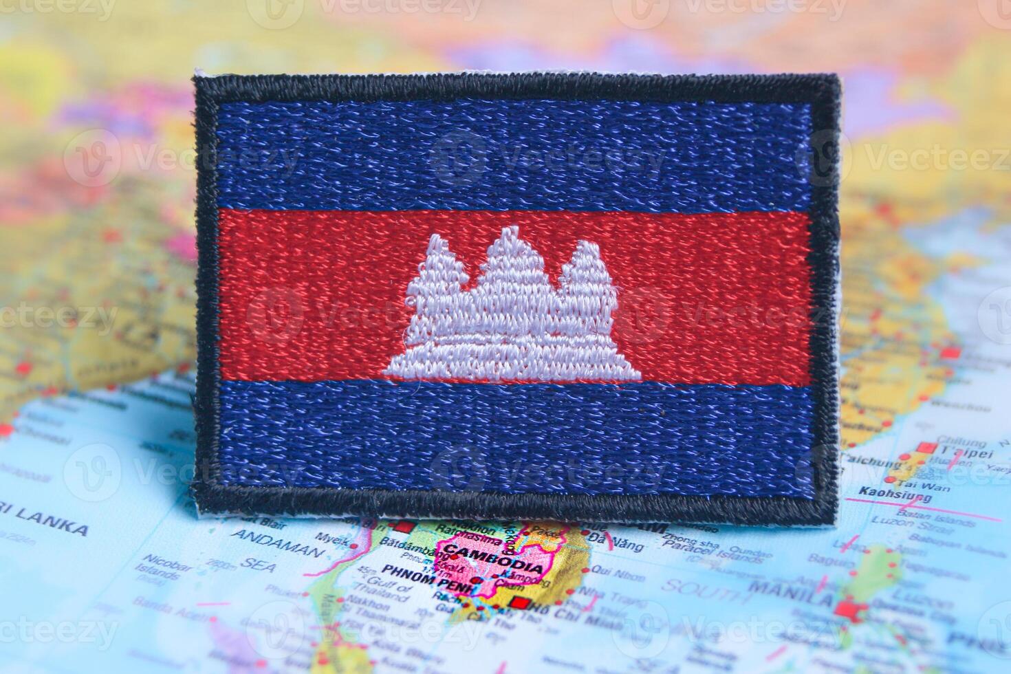 Cambodian national flag embroidery in eco style, placed on a map showing Cambodia in Southeast Asia. Featuring sustainable travel concepts with iconic landmarks. photo