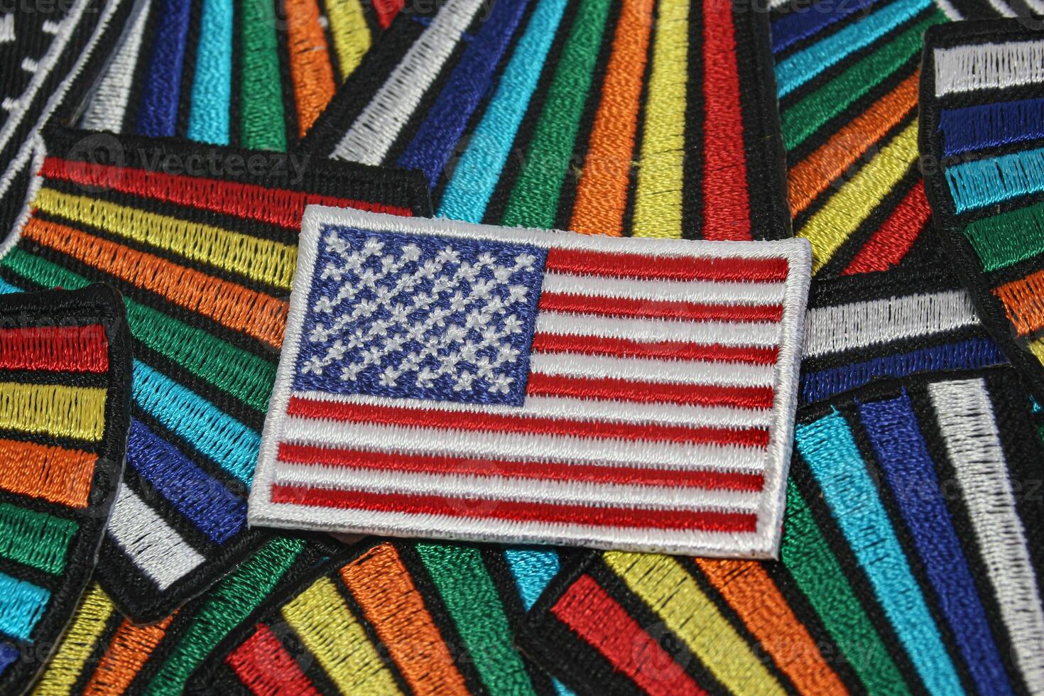Fabric US flag on rainbow thread background, showcasing handcrafted textile art that symbolizes diversity, inclusion, and pride in America. photo