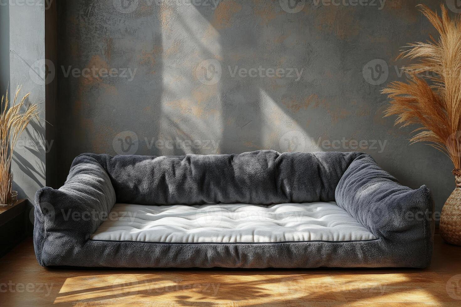 A gray dog bed sitting in front of a window photo