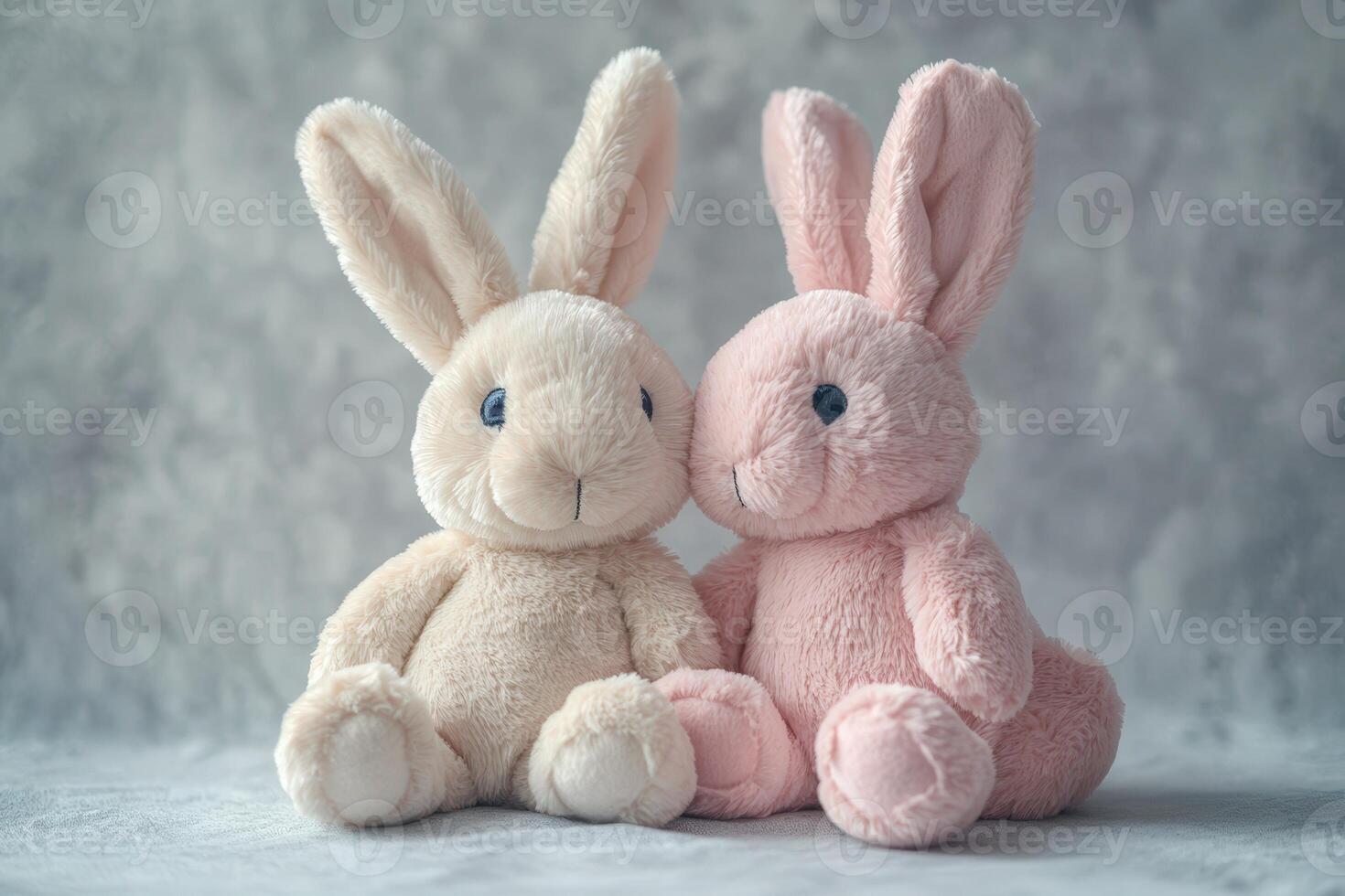 Two stuffed animals sit next to each other photo