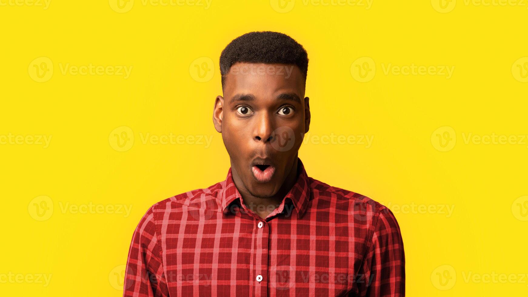 Portrait Of Surprised African American Guy Opened Mouth In Amazement, Shocked Black Millennial Man Looking Stunned And Impressed, Emotionally Reacting To News Over Yellow Background, Free Space photo