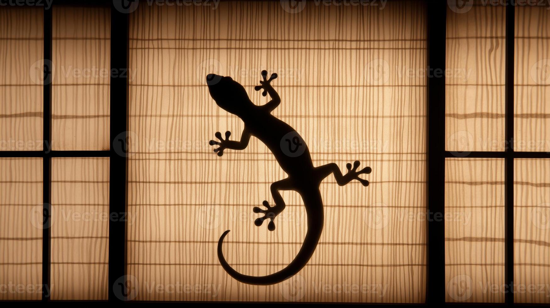 A lizard clings to a shoji screen, casting a striking silhouette during the evening. photo