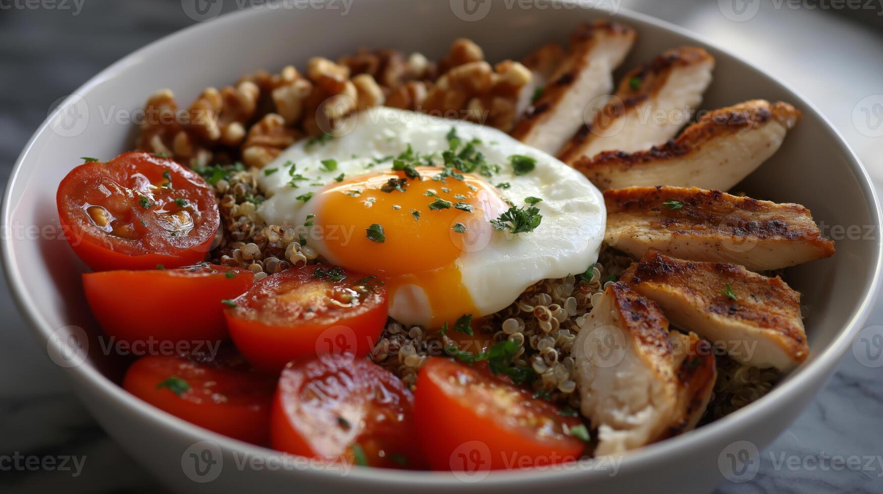 A nutritious breakfast bowl with quinoa, grilled chicken, tomatoes, and a poached egg. photo