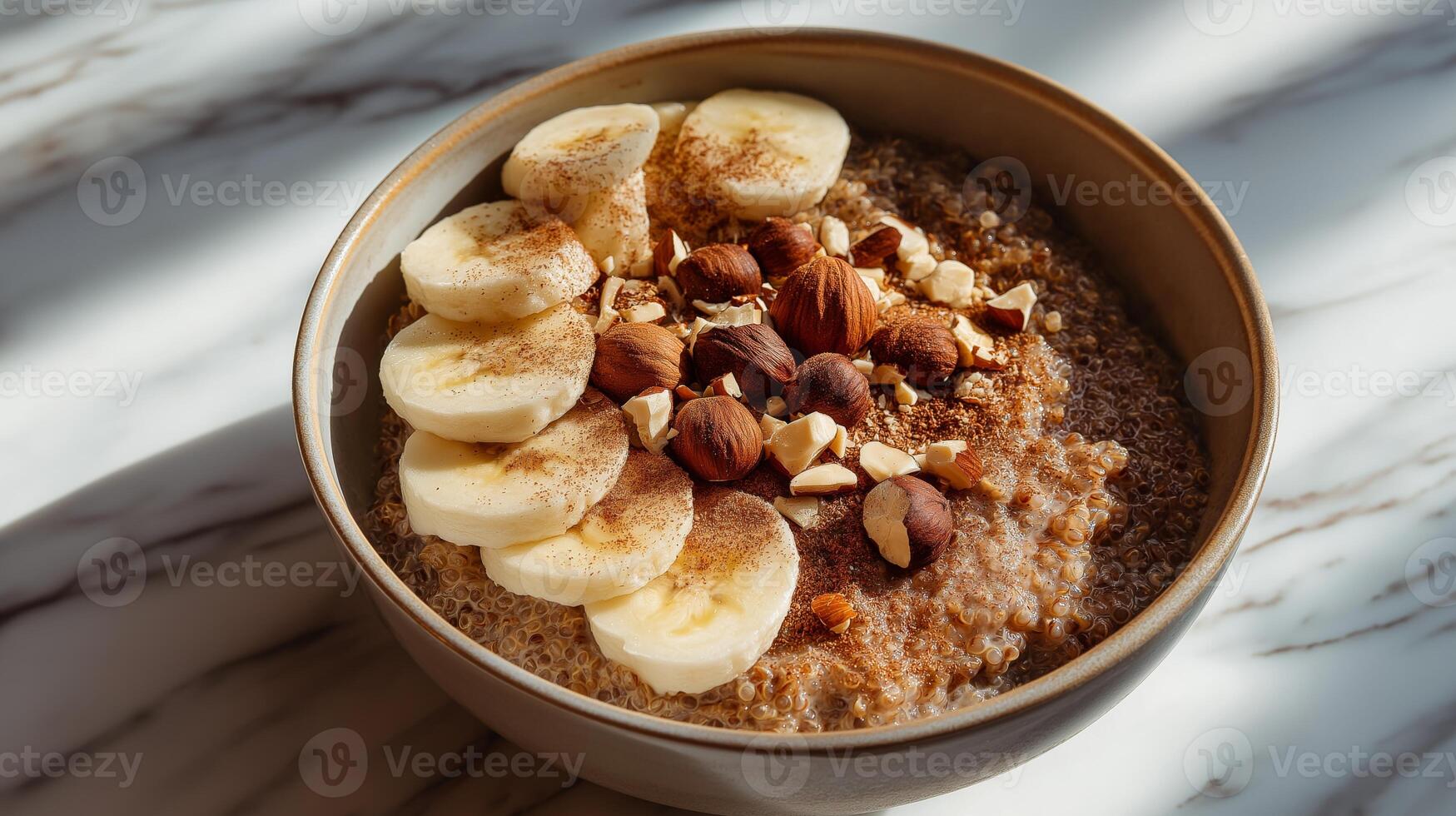 A nutritious bowl features quinoa, sliced bananas, and a mix of nuts, beautifully arranged. photo