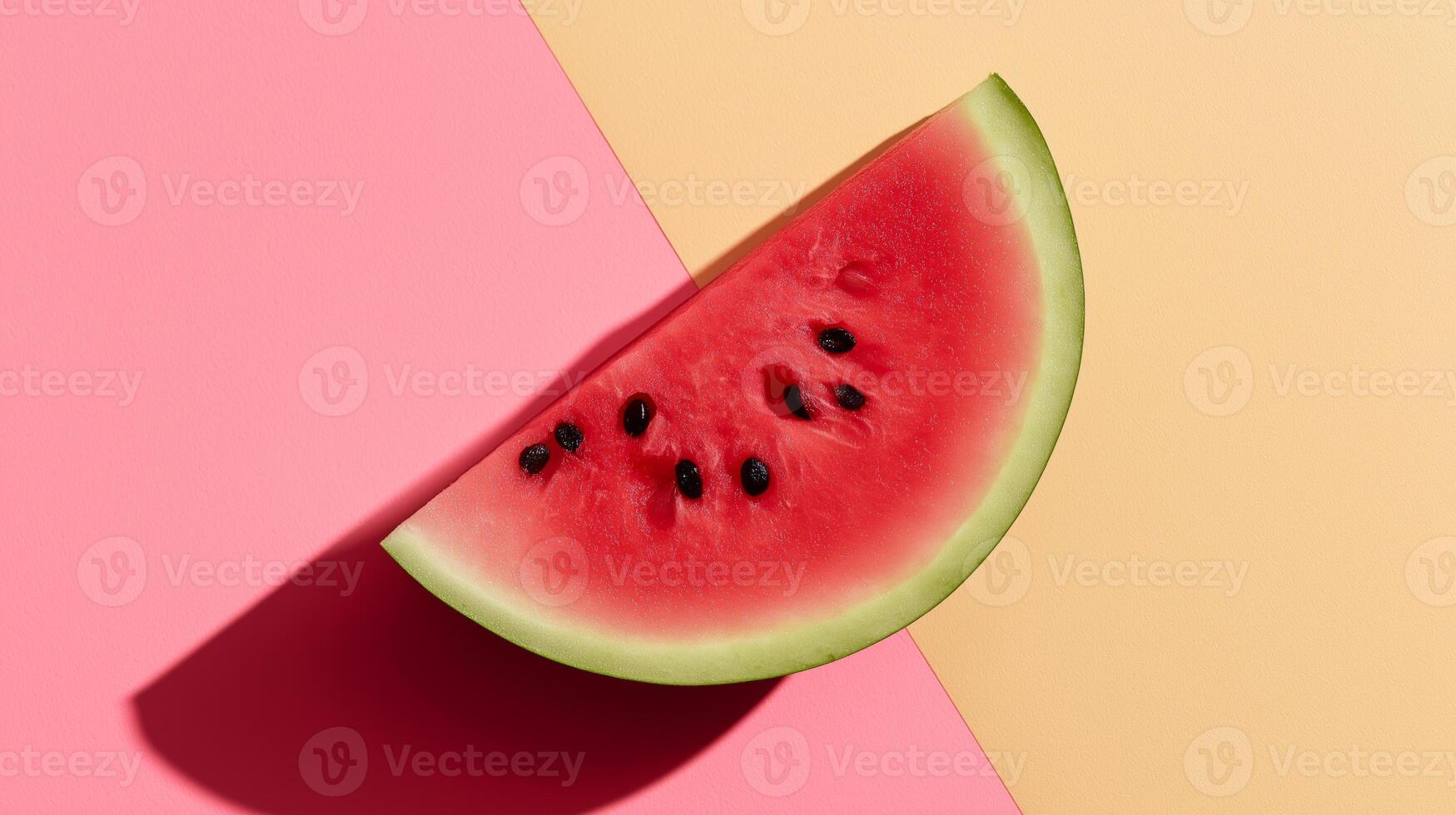 A fresh watermelon slice sits against a pink and yellow split background. photo