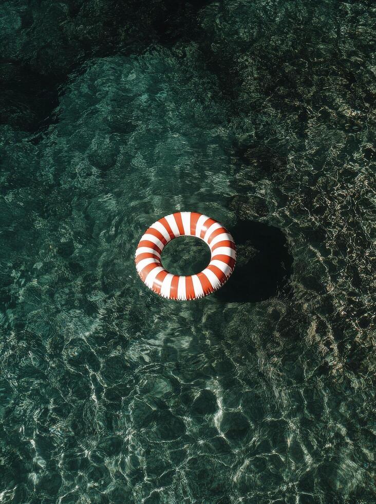 Floating Lifebuoy in Clear Turquoise Water on Sunny Day. photo