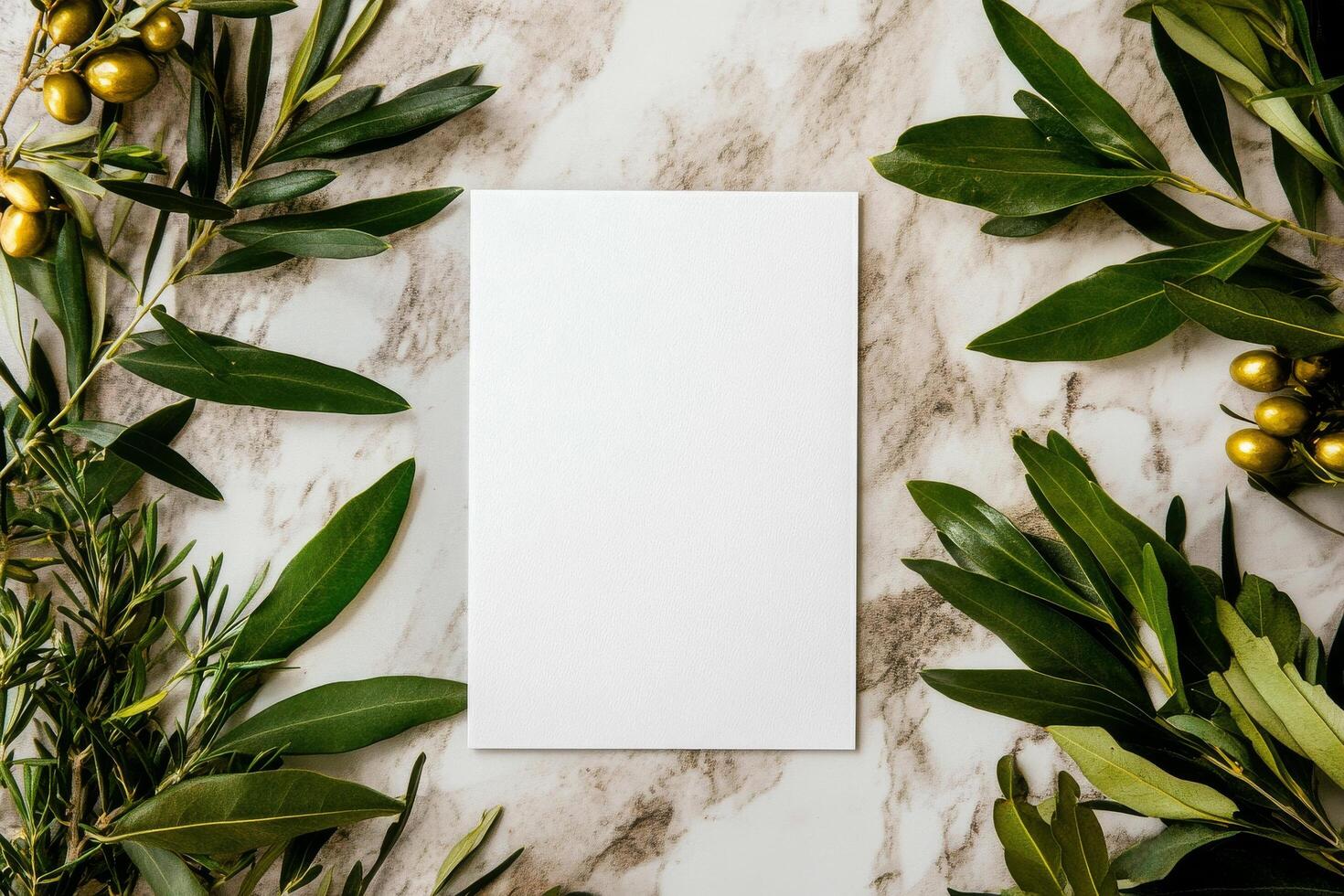 Blank Card Surrounded by Green Leaves on a Marble Surface in Natural Light photo