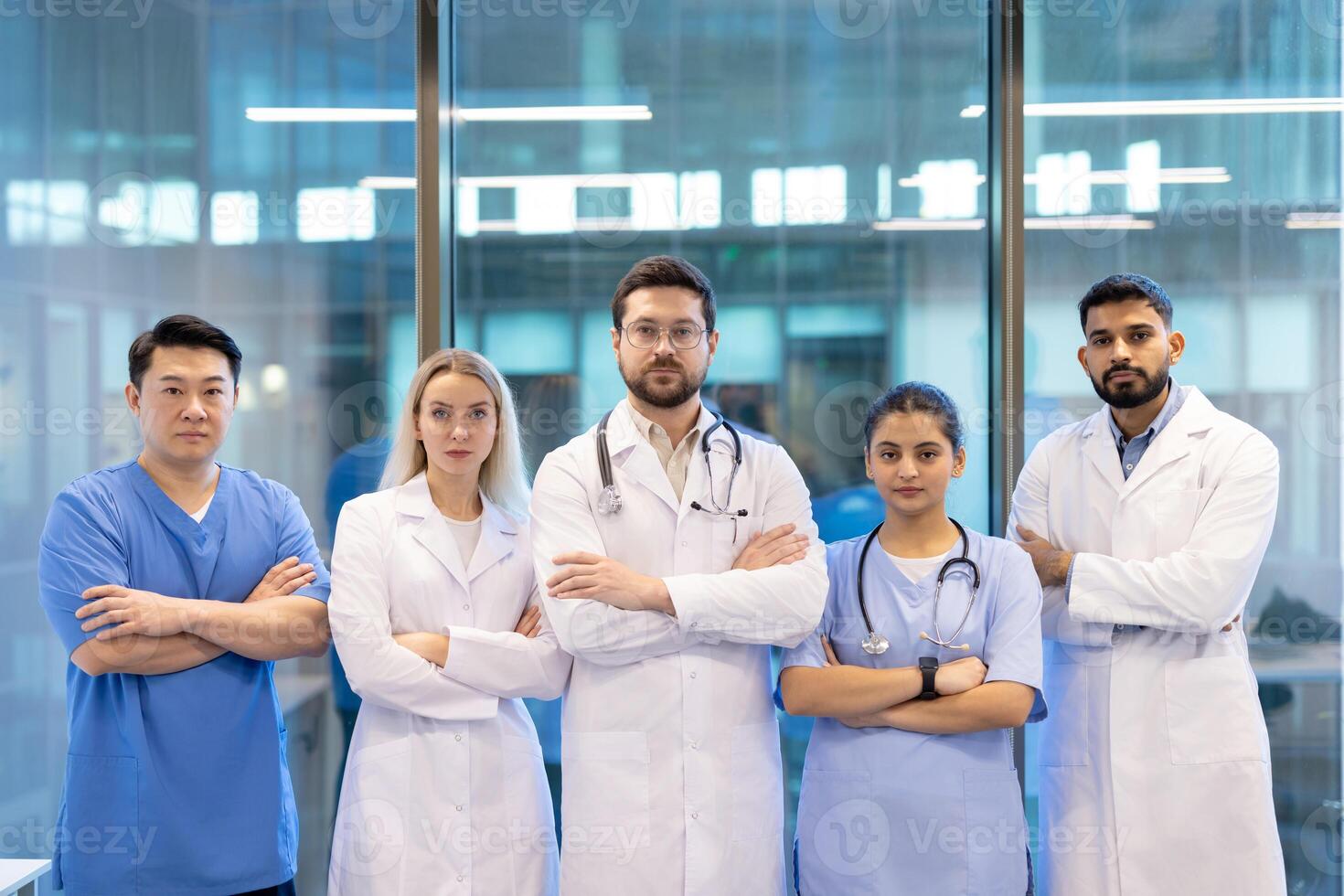 A diverse medical team stands together, arms crossed, conveying unity and expertise in a modern healthcare setting. photo
