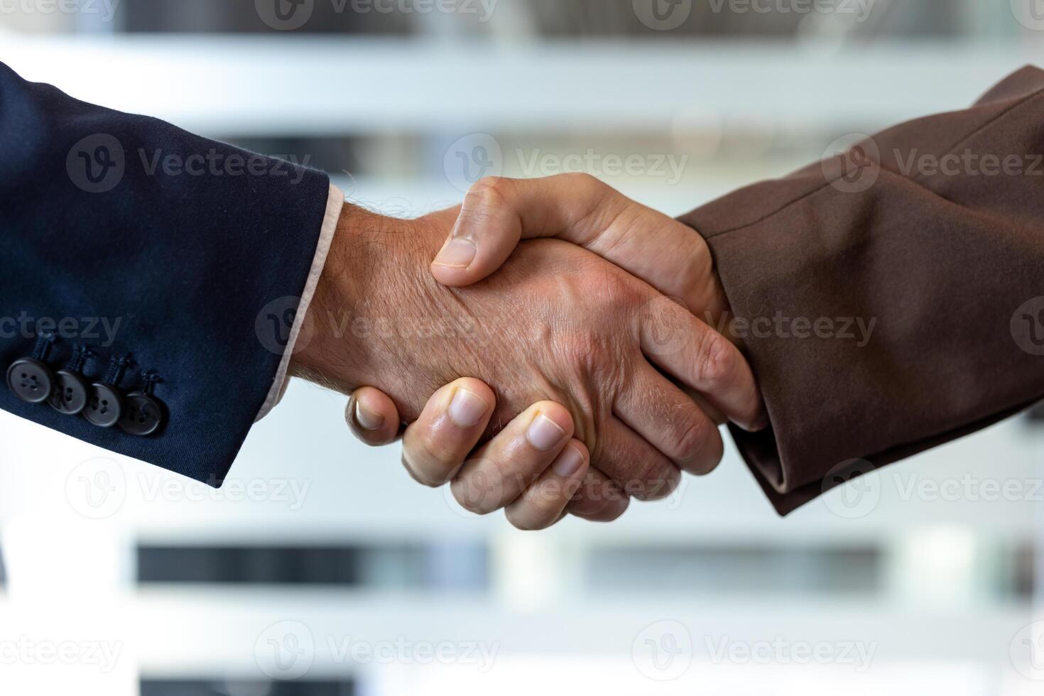 Two businessmen shaking hands. The image captures the essence of agreement and collaboration within a professional setting. photo