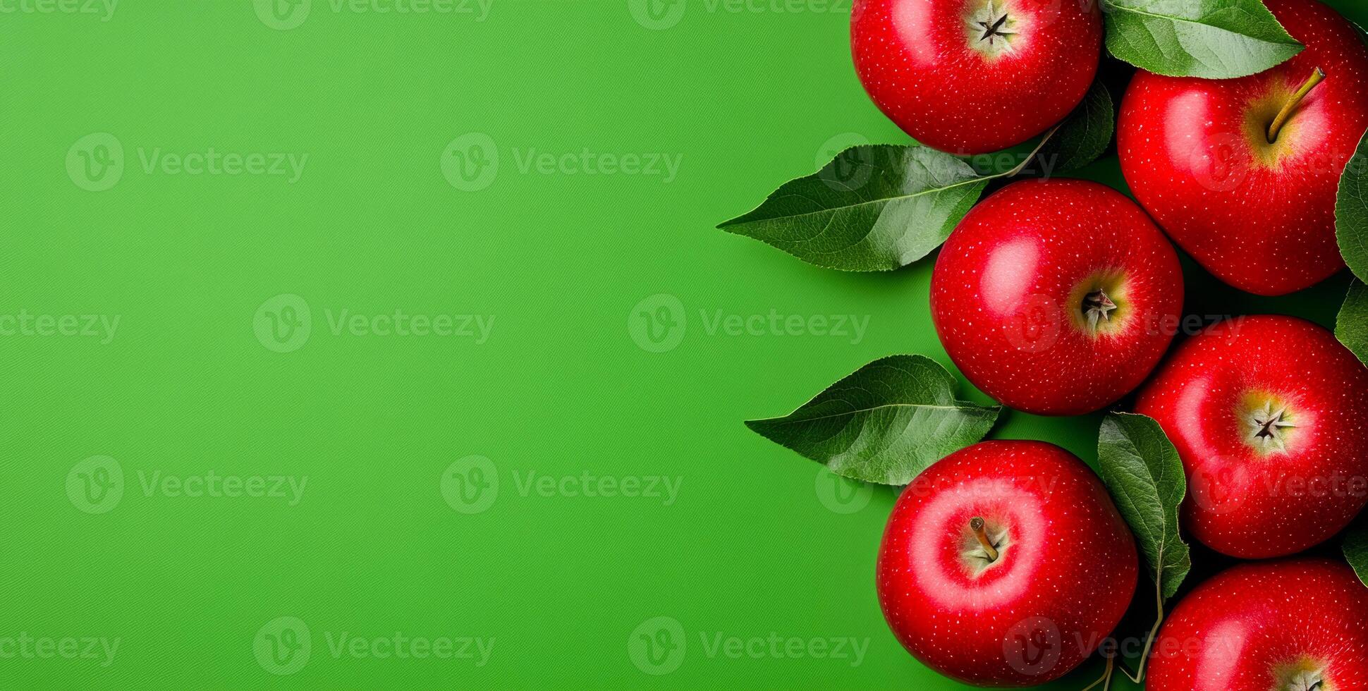 Red apples on green leaves. Fresh and juicy red apples arranged with green leaves on a bright green backdrop, showcasing their vibrant color. photo